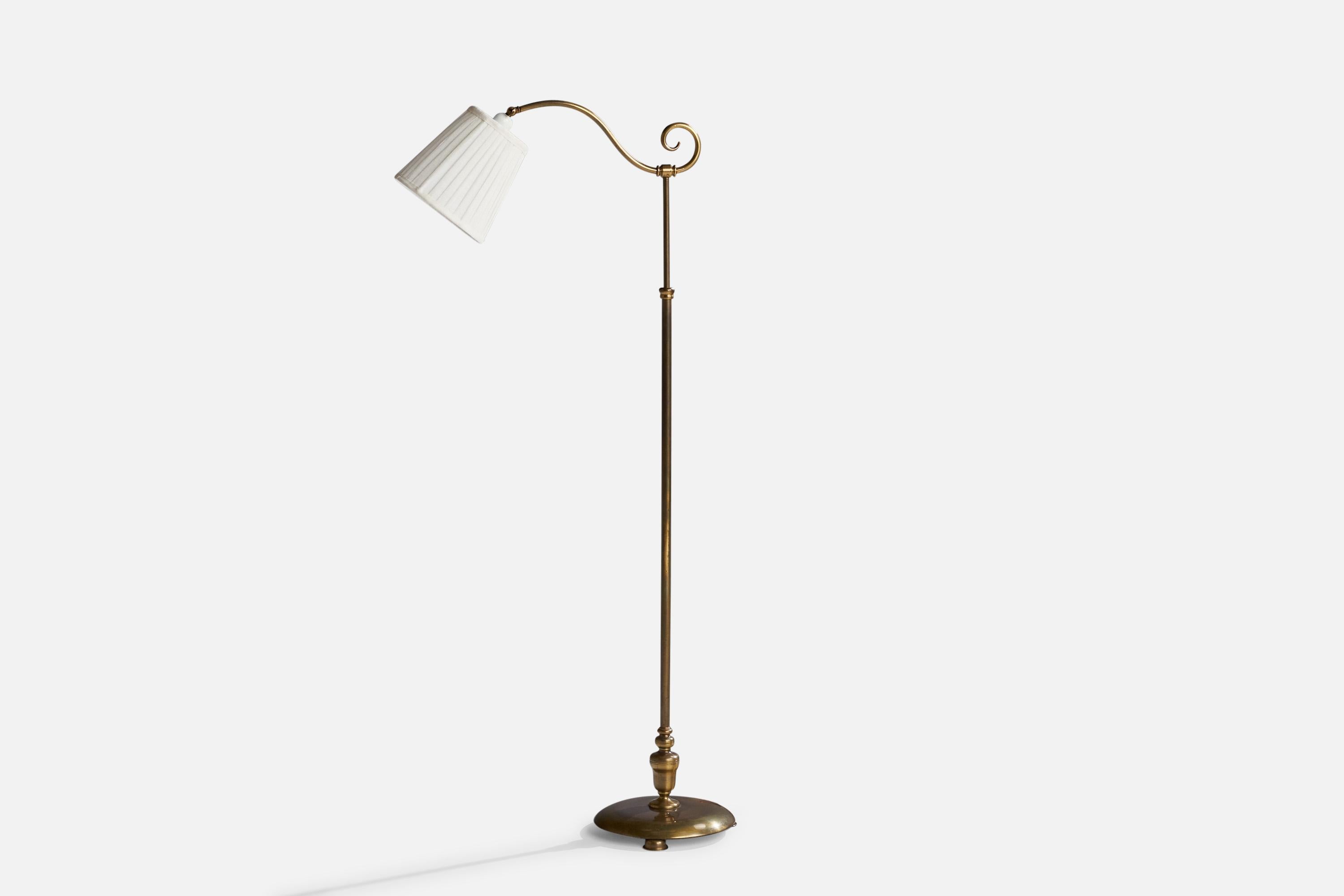 An adjustable brass and white fabric floor lamp designed and produced in Sweden, c. 1940s.

Dimensions will vary depending upon adjustment.
Overall Dimensions (inches): 57” H x 11”  W x 23” D
Stated dimensions include shade.
Bulb Specifications: