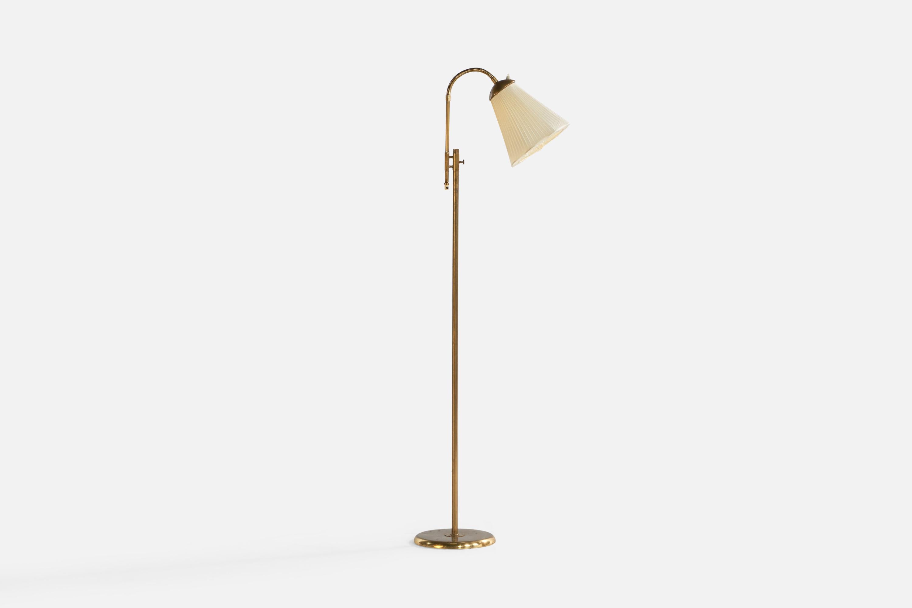 An adjustable brass and off-white fabric floor lamp designed and produced in Sweden, c. 1960s.

Note that cord feeds from bottom of stem connected to socket.

Overall Dimensions (inches): 59.25” H x 10” W x 20.5” D. Stated dimensions include