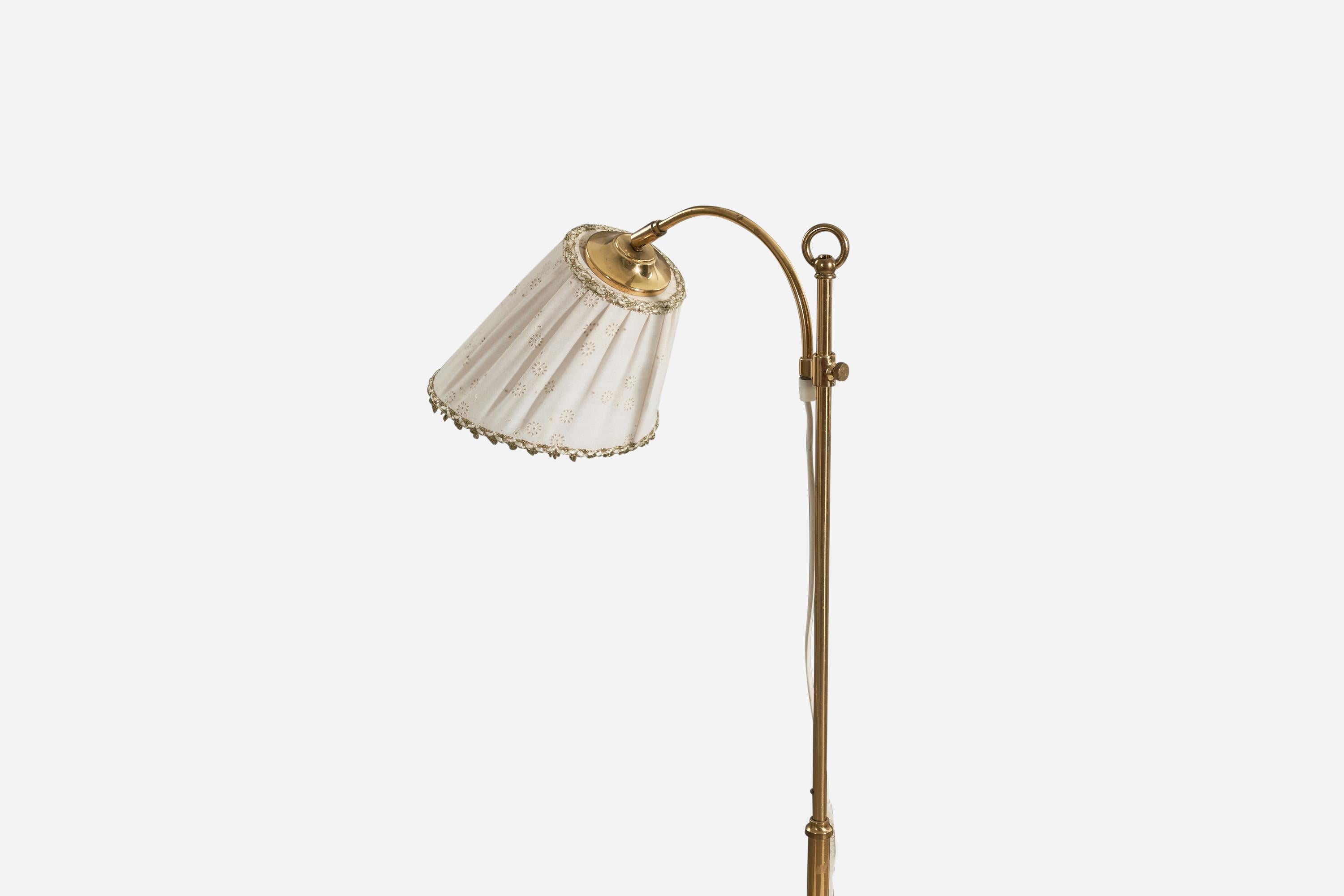 A brass and fabric floor lamp designed and produced by a Swedish designer, Sweden, c. 1970s.

Sold with Lampshade. 
Stated dimensions refer to the floor lamp with the shade.
 