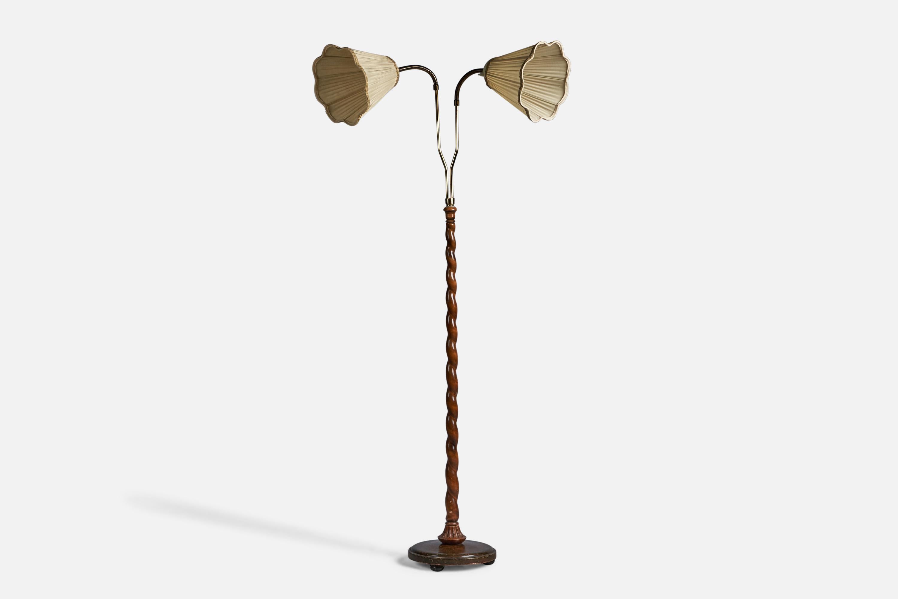 A two-armed carved dark-stained wood, brass and fabric floor lamp, designed and produced in Sweden, c. 1930s.

Overall Dimensions (inches): 64.75