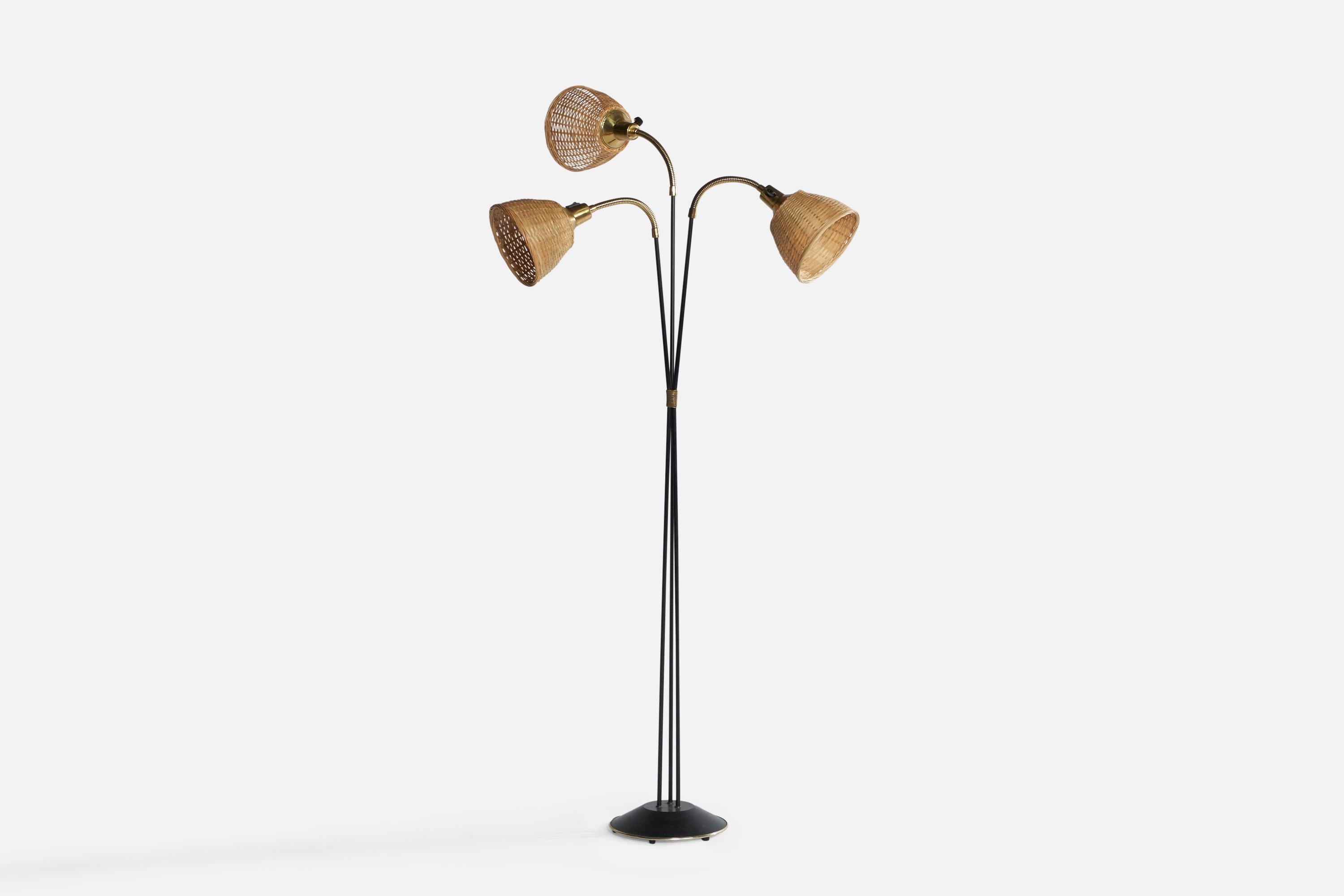A brass, black-lacquered iron and rattan floor lamp designed and produced in Sweden, 1950s.

Overall Dimensions (inches): 55.1” H x 28.55” W x 19.75” D. Stated dimensions include shades.
Bulb Specifications: E-26 Bulbs
Number of Sockets: 2
All