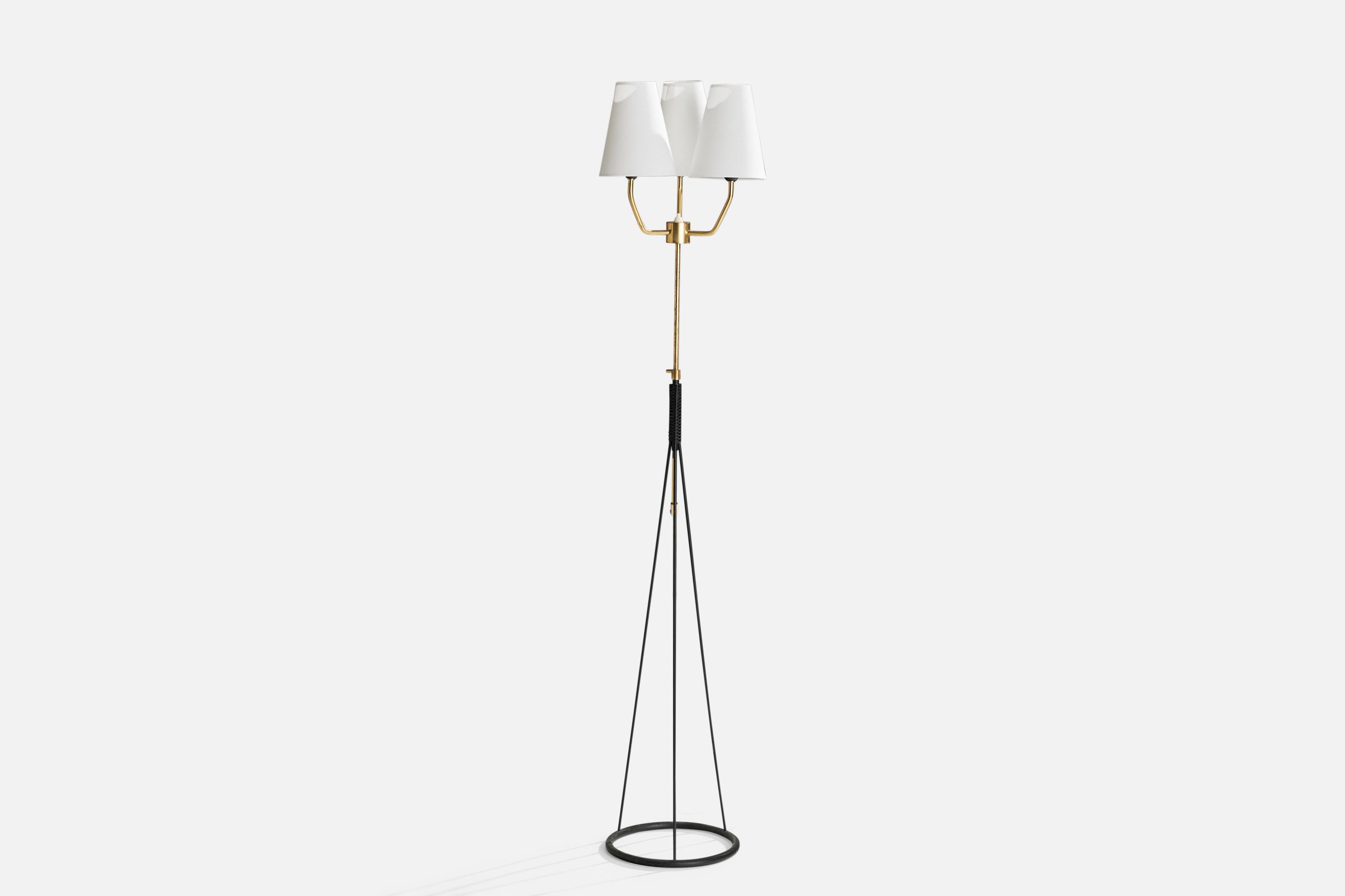 An adjustable brass, black-lacquered metal, white fabric and rubber floor lamp designed and produced in Sweden, c. 1960s.

Overall Dimensions (inches): 60.63”  H x 11.42” W x 11.42” D
Stated dimensions include shade.
Bulb Specifications: E-26