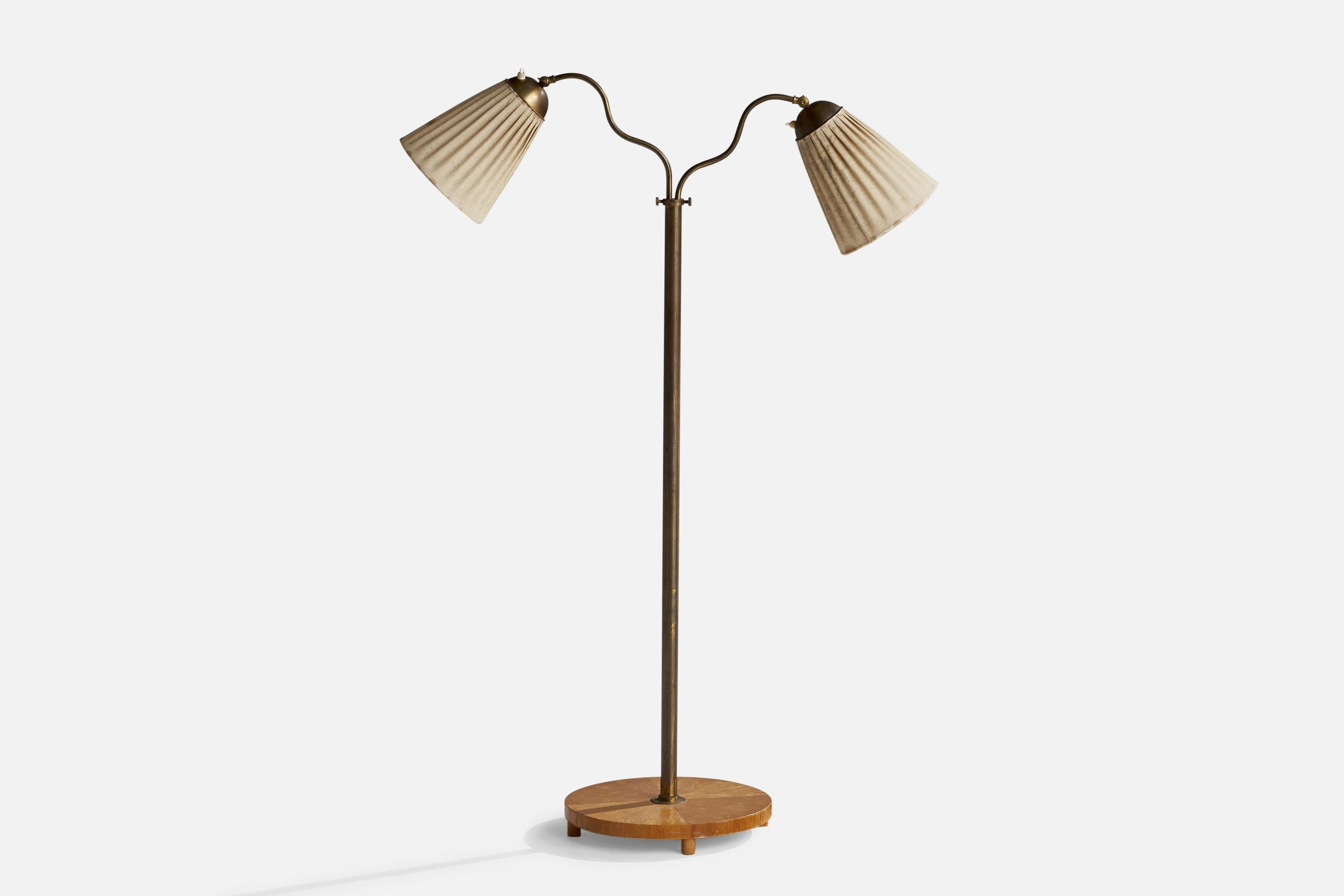 An adjustable floor lamp designed and produced in Sweden, 1940s.

Dimension variable.

Overall Dimensions (inches): 50.5” H x 33” W x 33” D
Stated dimensions include shade.
Bulb Specifications: E-26 Bulb
Number of Sockets: 2
All lighting will be