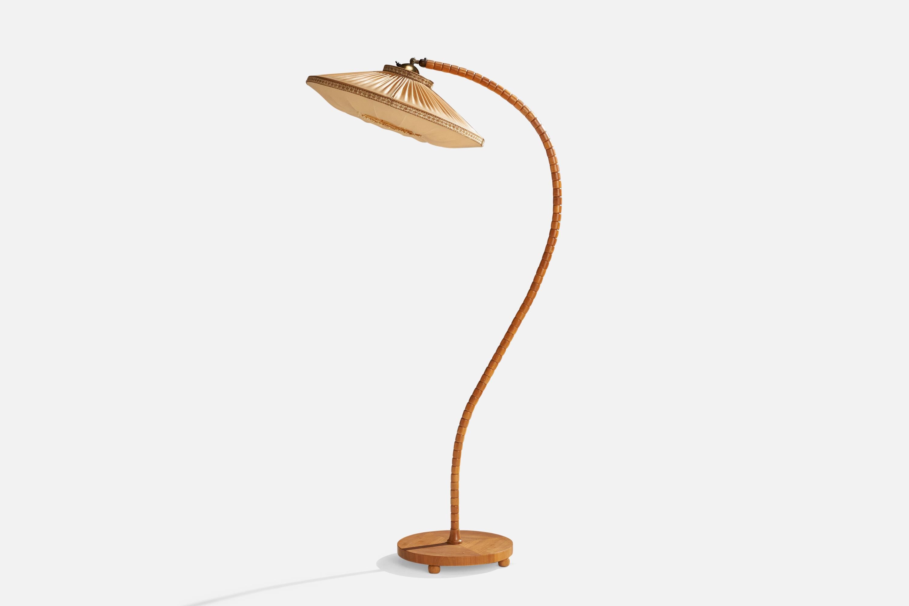 An oak, brass and beige fabric floor lamp designed and produced in Sweden, 1940s.

Overall Dimensions (inches): 59” H x 21.5” W x 28”  D
Stated dimensions include shade.
Bulb Specifications: E-26 Bulb
Number of Sockets: 1
All lighting will be
