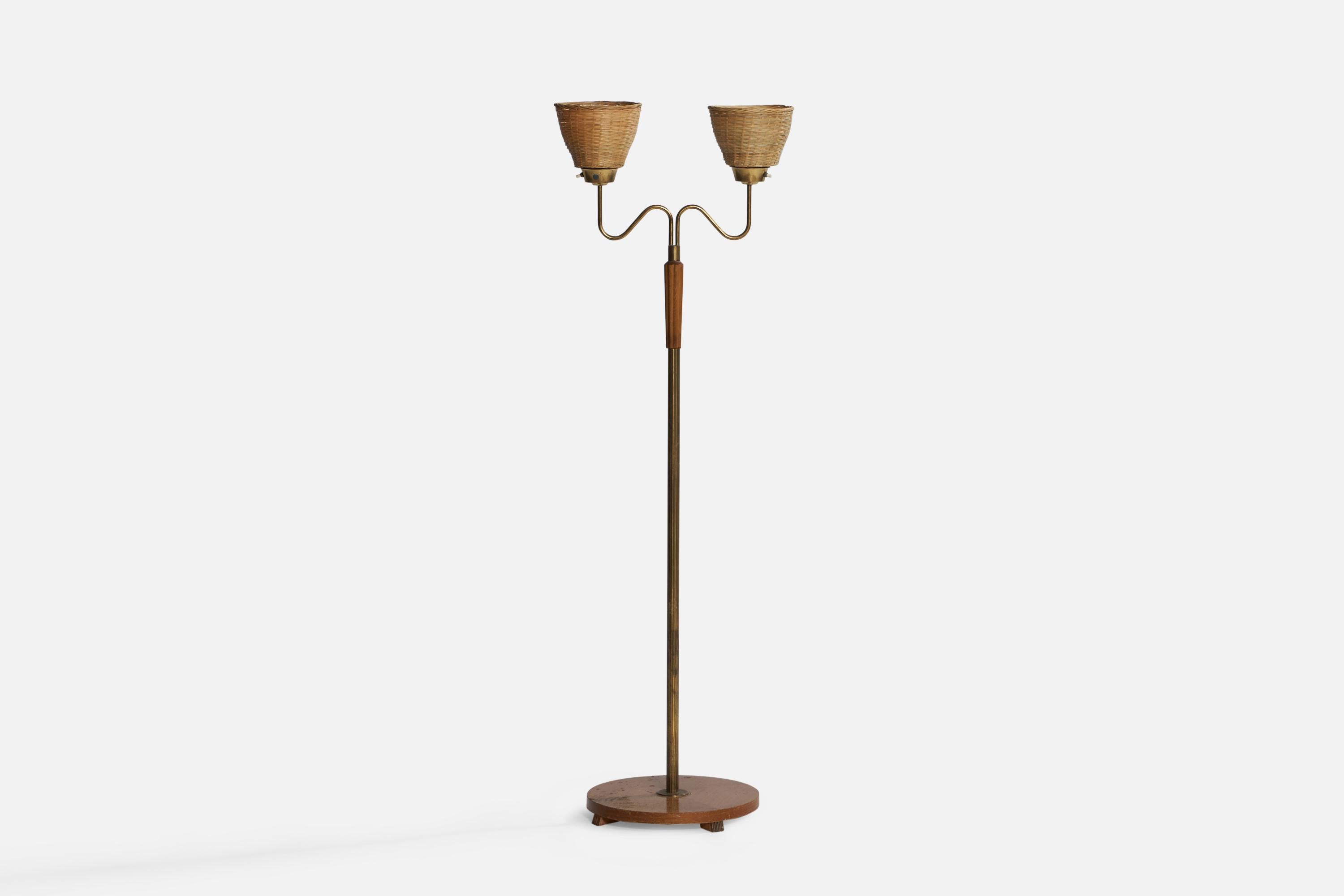 A two-armed brass, stained oak and rattan floor lamp designed and produced in Sweden, 1940s.

Overall Dimensions (inches): 59.1” H x 19.55” W x 14.5” D. Stated dimensions include shade.
Bulb Specifications: E-26 Bulbs
Number of Sockets: 2
All