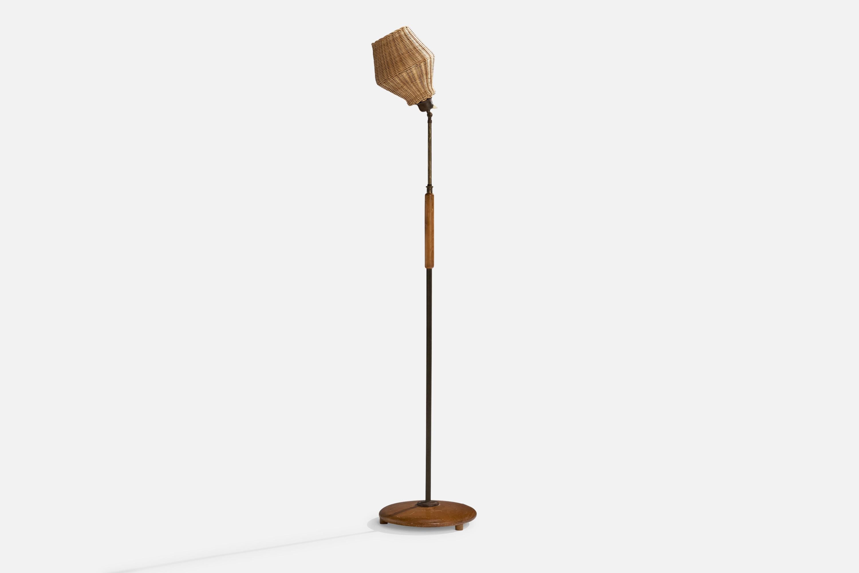 An adjustable brass, oak and rattan floor lamp designed and produced in Sweden, 1950s.

Overall Dimensions (inches): 56.5”  H x 13” W x 16.5” D
Stated dimensions include shade.
Bulb Specifications: E-26 Bulb
Number of Sockets: 1
All lighting will be