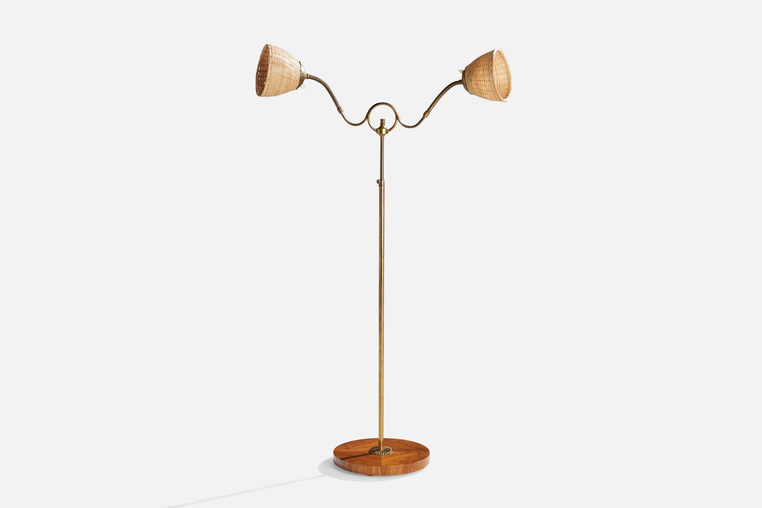 An adjustable brass, rattan and elm floor lamp designed and produced in Sweden, 1940s.

Overall Dimensions (inches): 60” H x 32” W x 9” D
Stated dimensions include shade.
Bulb Specifications: E-26 Bulb
Number of Sockets: 2
All lighting will be