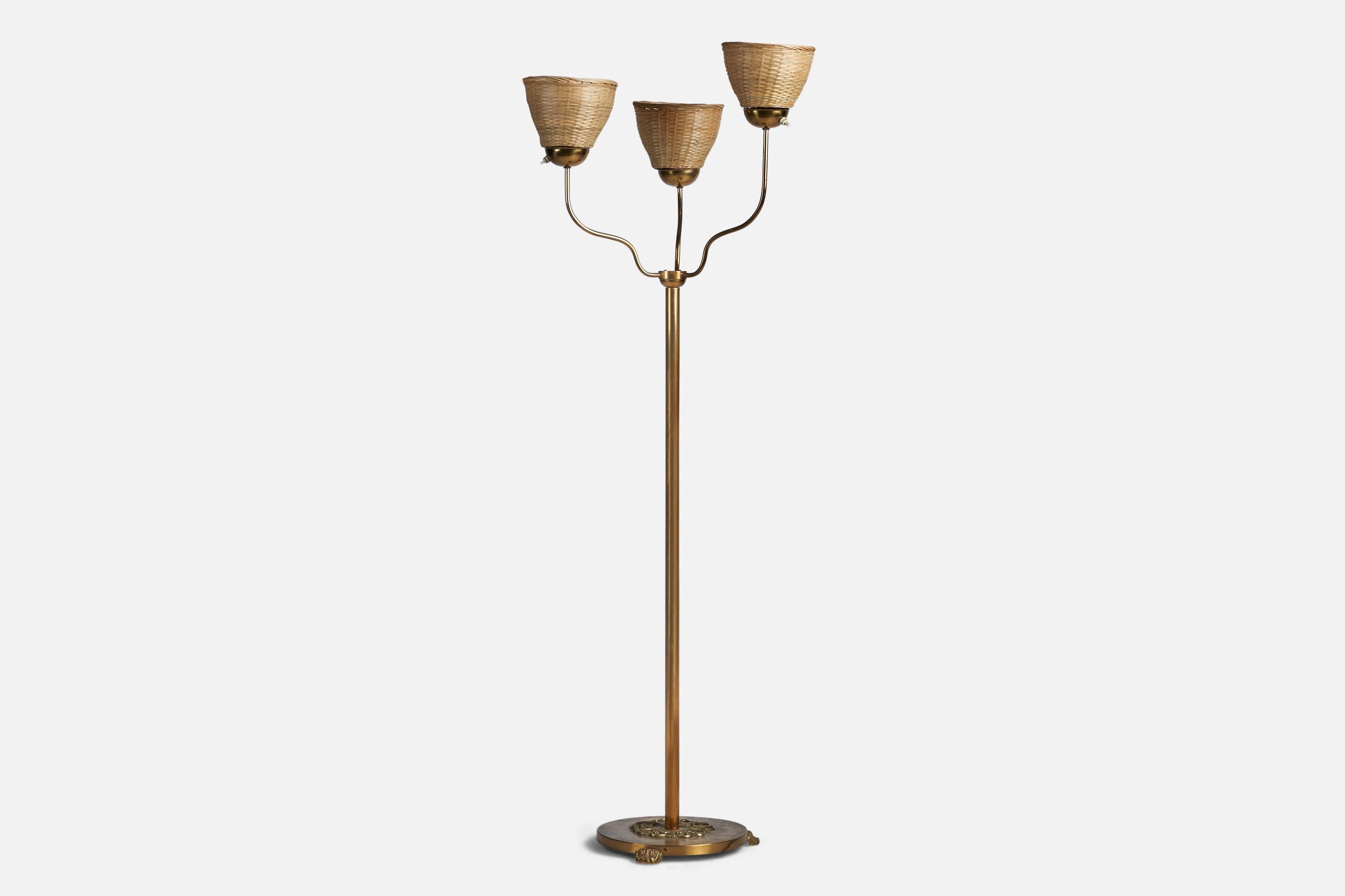 A three-armed brass and rattan floor lamp designed and produced in Sweden, c. 1930s.

Overall Dimensions (inches): 61.25” H x 22” Diameter
Bulb Specifications: E-26 Bulb
Number of Sockets: 3
All lighting will be converted for US usage. We are unable