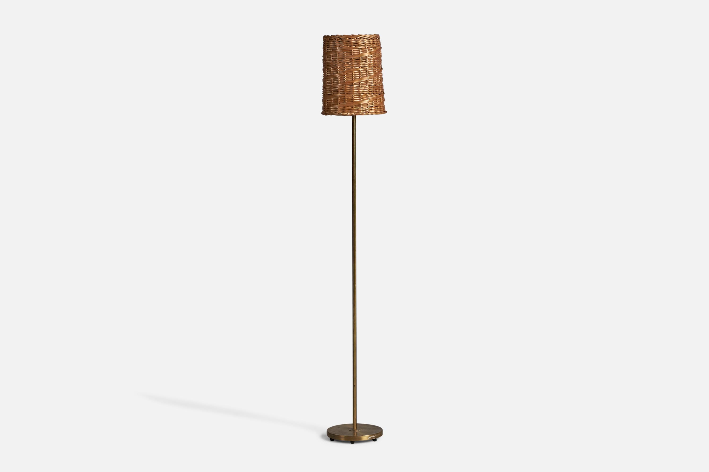 A brass and rattan floor lamp, designed and produced in Sweden, c. 1940s.

Overall Dimensions (inches): 60