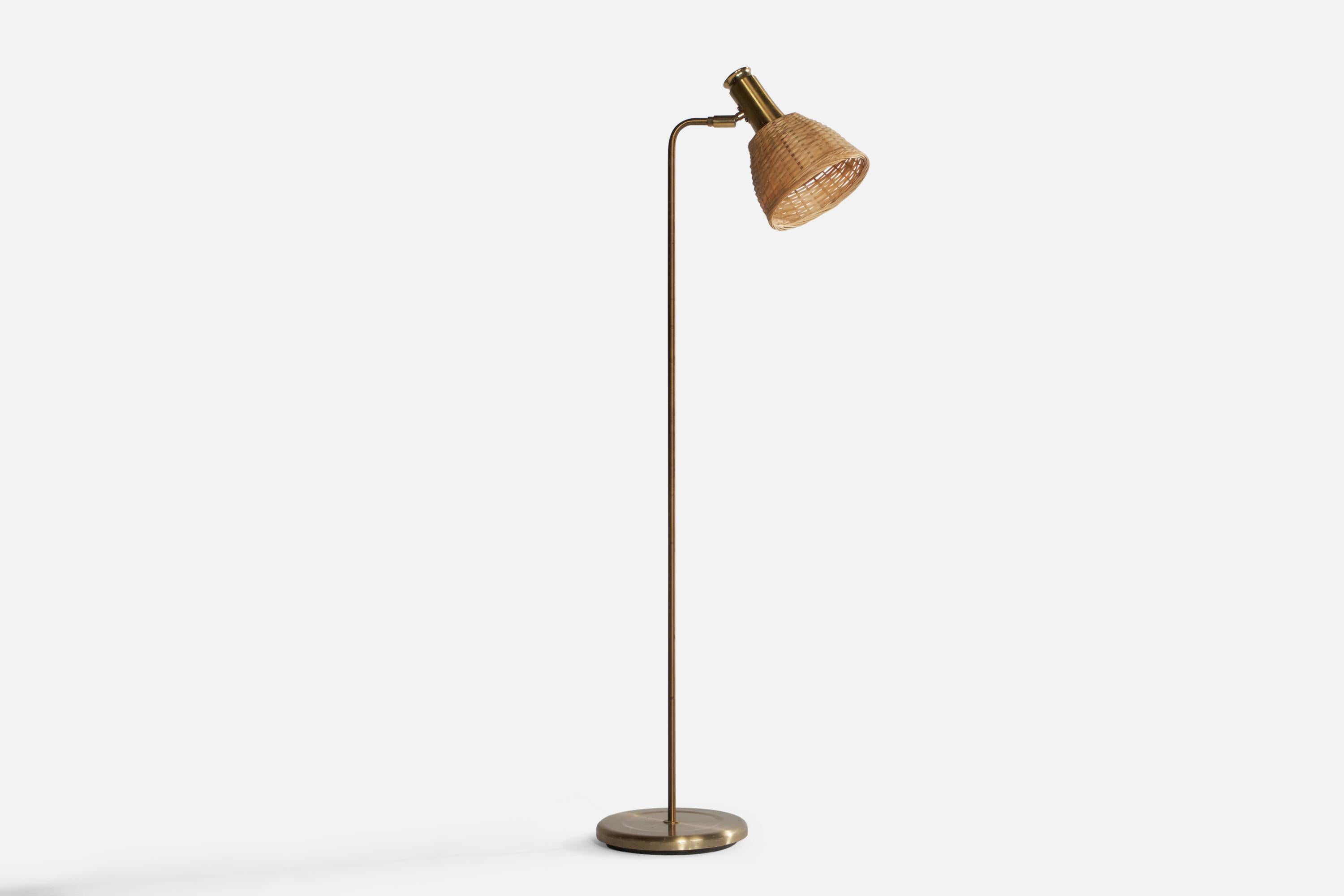 An adjustable brass and rattan floor lamp designed and produced in Sweden, c. 1960s.

Overall Dimensions (inches): 48” H x 9.5” W x 18” D. Stated dimensions include shade.
Dimensions  variable based on position of light.
Bulb Specifications: E-26