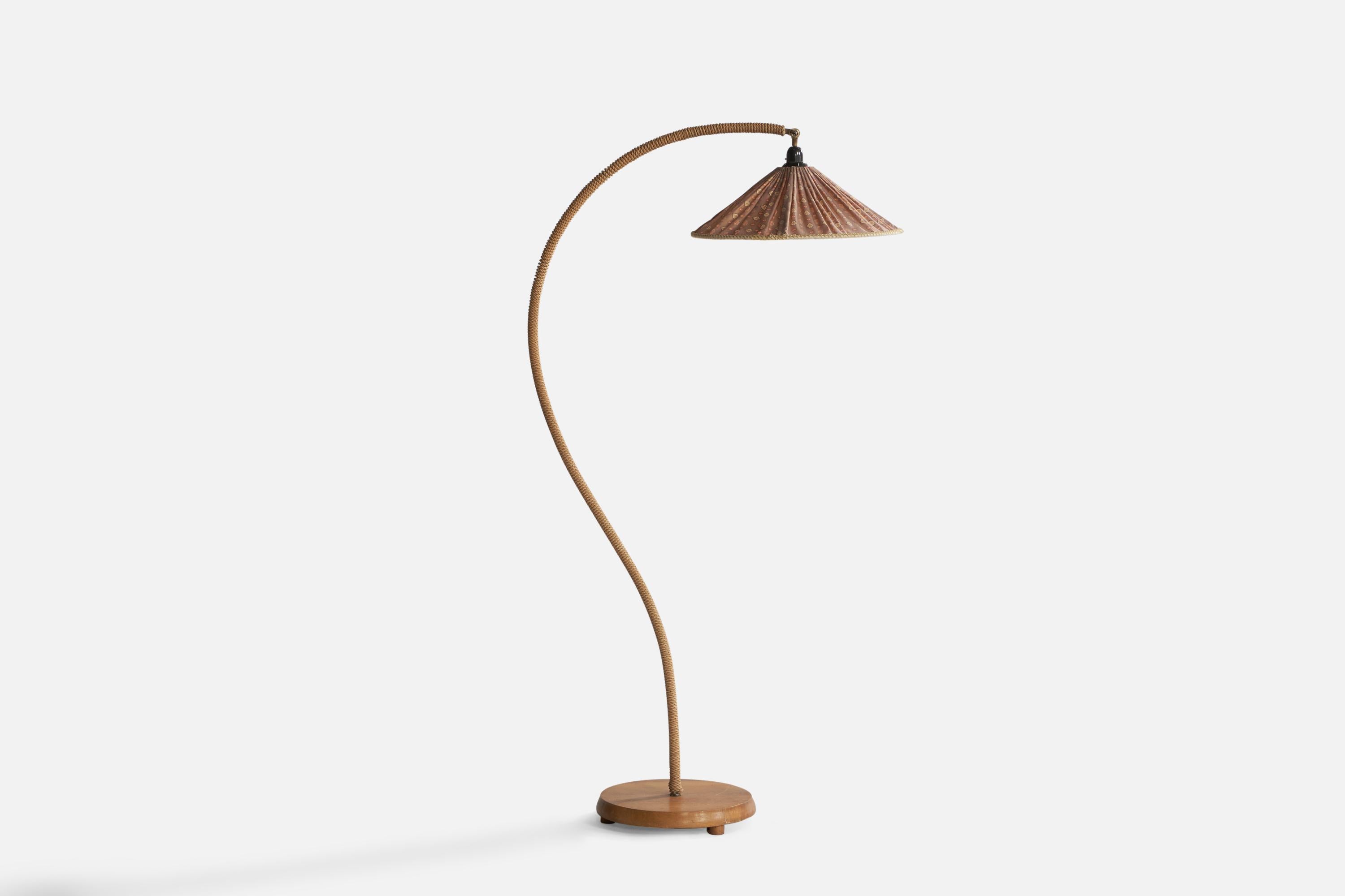An adjustable brass, rope elm and fabric floor lamp designed and produced in Sweden, 1940s.

Overall Dimensions (inches): 59.65” H x 17.75” W x 31.25” Depth. Stated dimensions include shade.
Dimensions vary based on angle of light.
Bulb