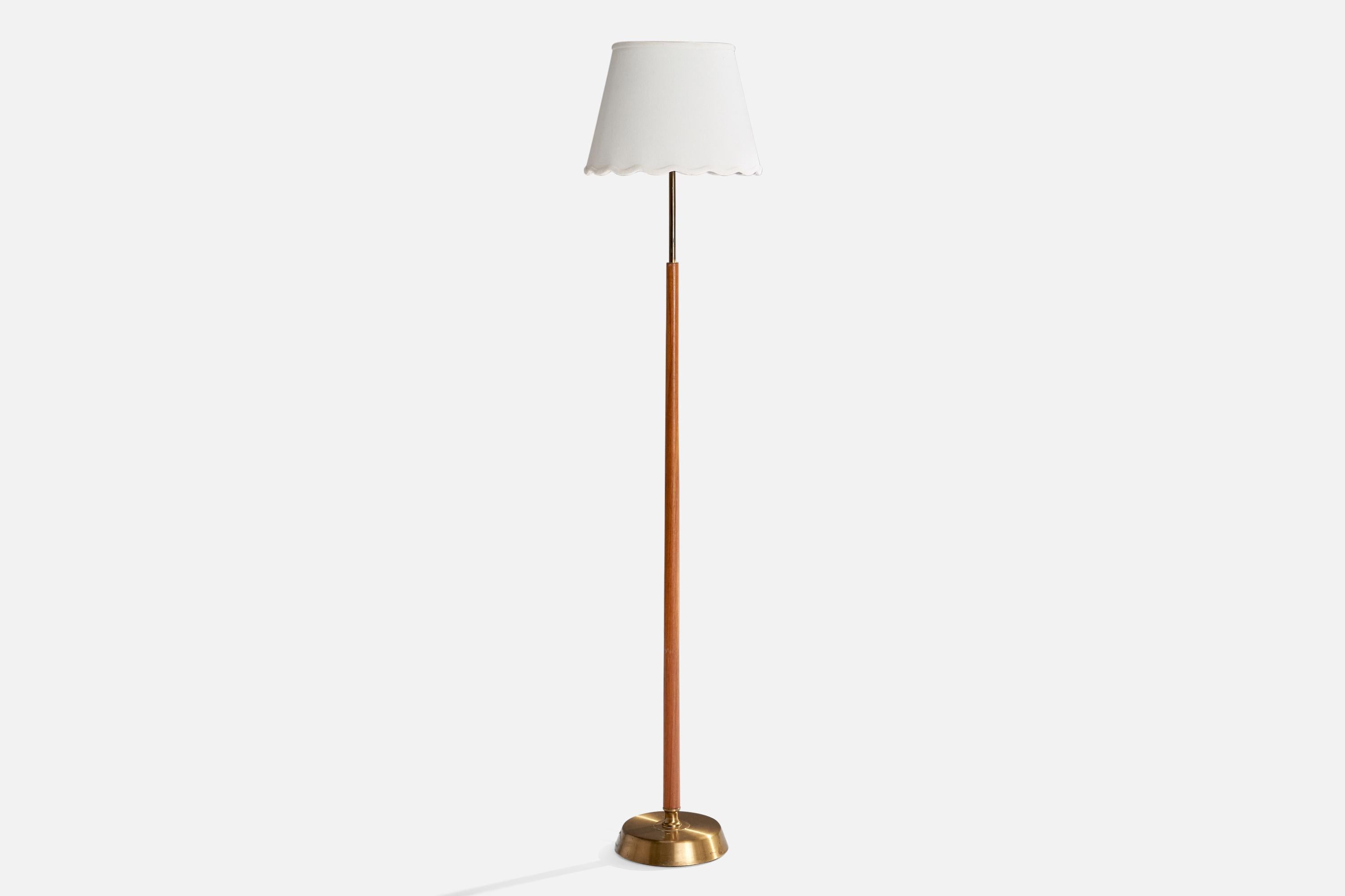 Lampadaire en laiton, teck et tissu blanc conçu et produit en Suède, C.C. 1950.

Dimensions de la lampe avec abat-jour (pouces) : 57