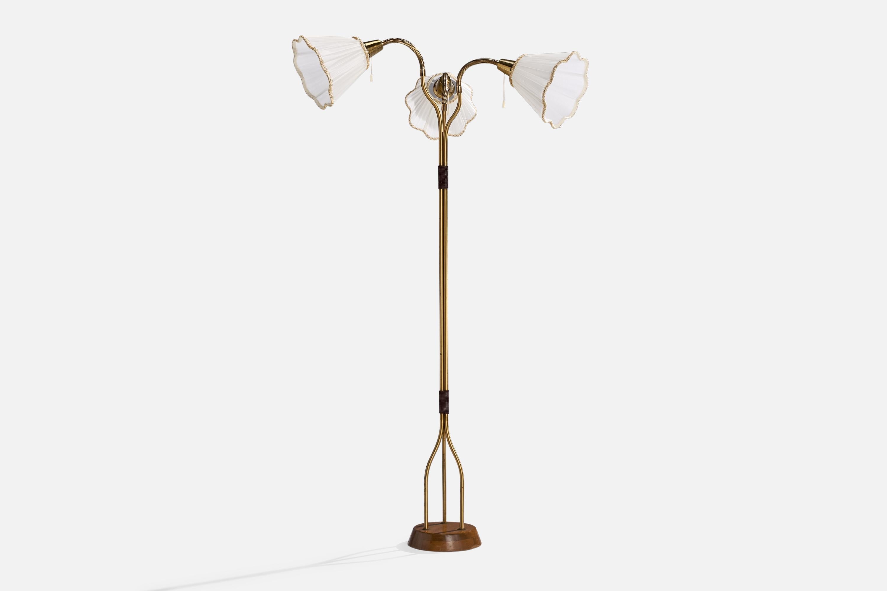 A brass, teak, white fabric and plastic cord floor lamp designed and produced in Sweden, 1950s.

Overall Dimensions (inches): 56” H x 33” W x 16” D
Stated dimensions include shade.
Bulb Specifications: E-26 Bulb
Number of Sockets: 3
All lighting