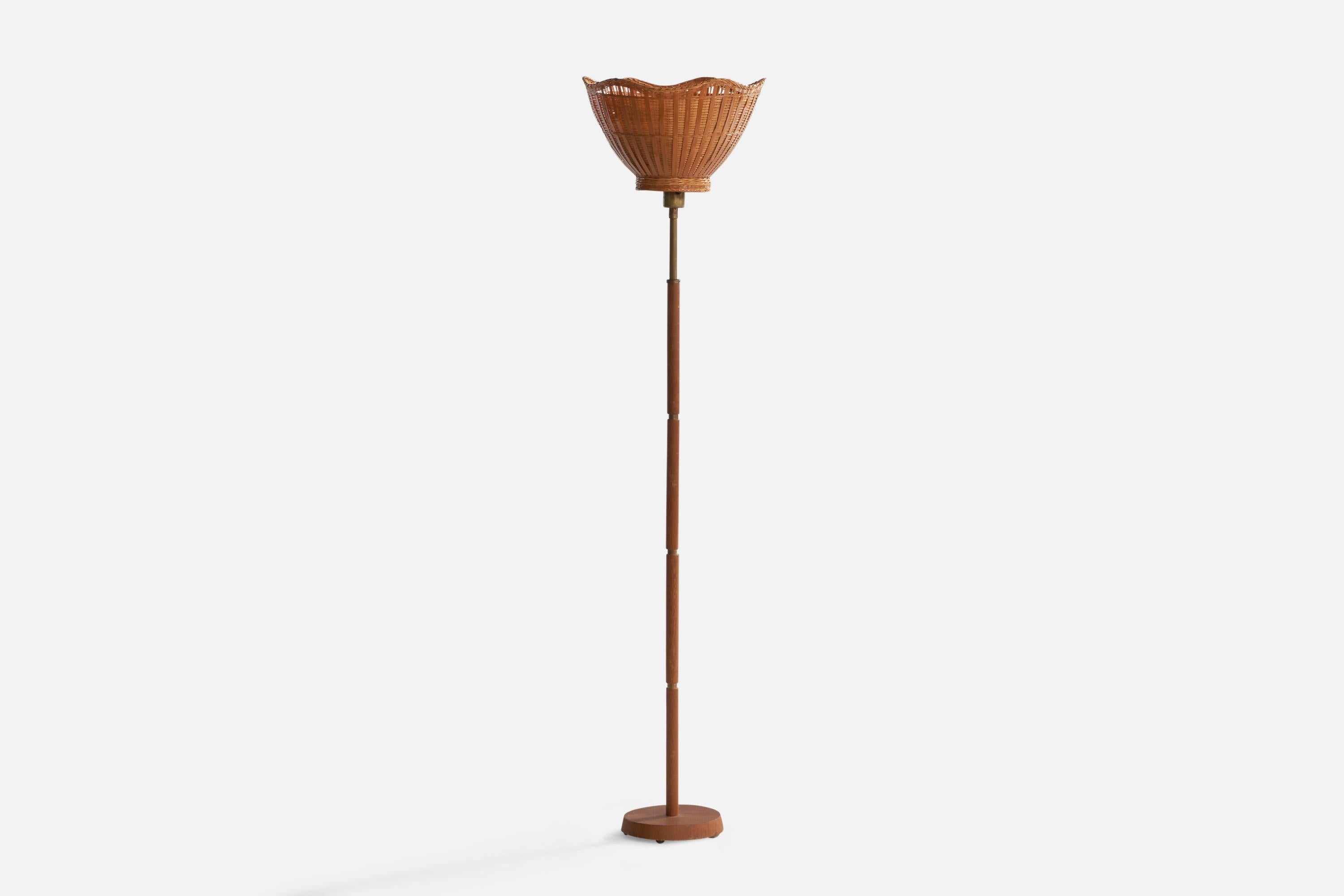 A brass, teak and rattan floor lamp designed and produced in Sweden, 1950s.

Overall Dimensions (inches): 57.25” H x 13.6” Diameter. Stated dimensions include shade. 
Bulb Specifications: E-26 Bulb
Number of Sockets: 1
All lighting will be converted