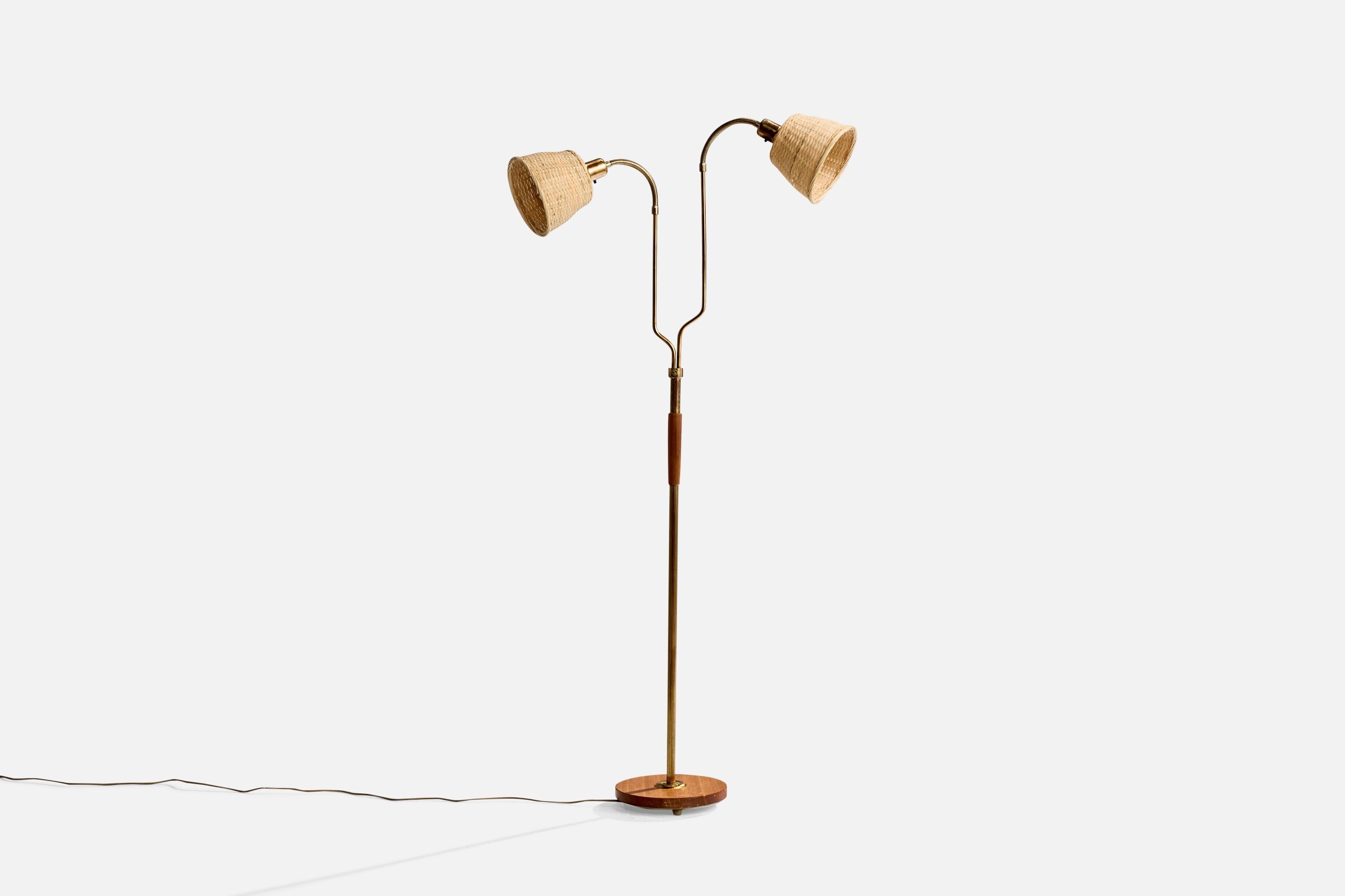 A brass, teak and rattan floor lamp designed and produced in Sweden, c. 1950s.

Dimensions of Lamp with Shade (inches): 61.25