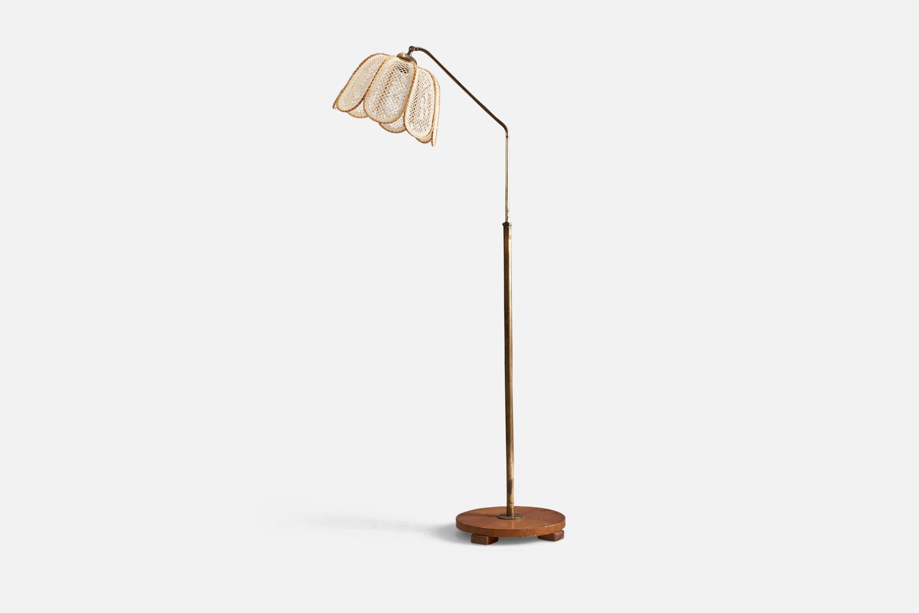 A brass, wood and embroidery fabric floor lamp designed and produced by a Swedish Designer, Sweden, 1940s.

Socket takes standard E-26 medium base bulb.

There is no maximum wattage stated on the fixture.