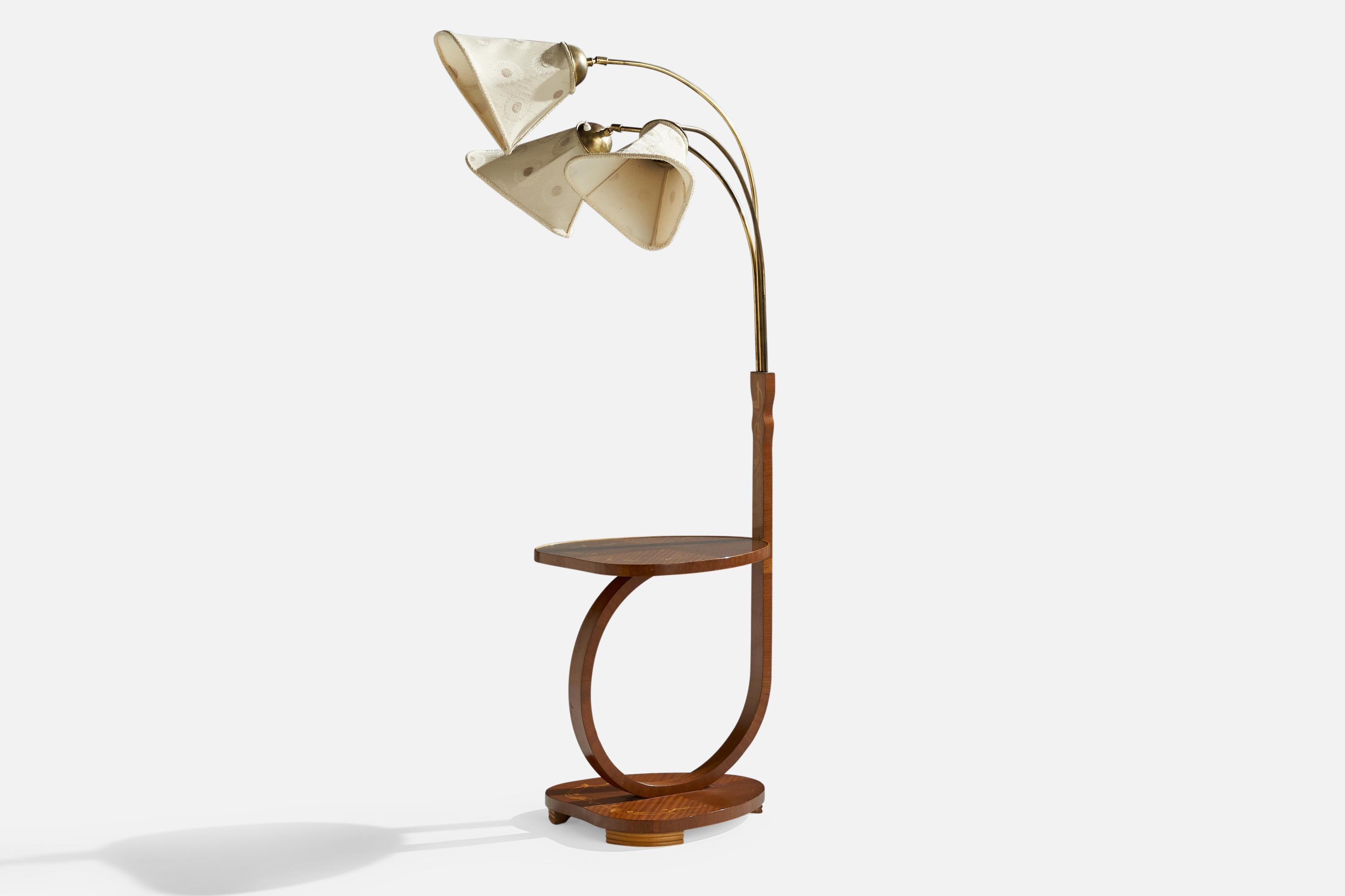 A brass, wood and fabric adjustable three-armed floor lamp with side table, designed and produced in Sweden, 1930s.

Overall Dimensions (inches): 59.25” H x 50.35” W x 28” D
Dimensions vary based on position of lights.
Bulb Specifications: E-26