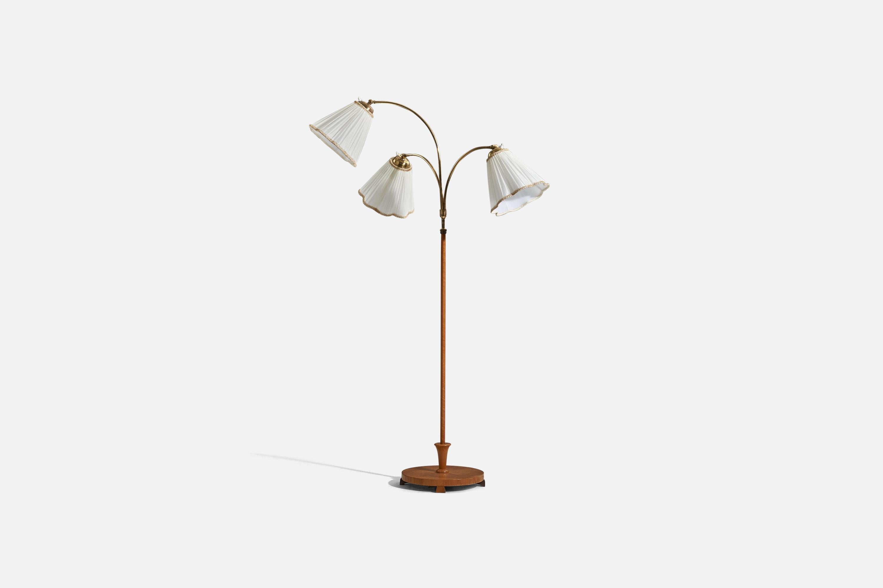 A brass, wood and fabric floor lamp designed and produced by a Swedish designer, Sweden, 1940s. 

Sold with lampshade. 
Dimensions stated refer to the floor lamp with the shade.
Variable dimensions, measured as illustrated in the first image.
 