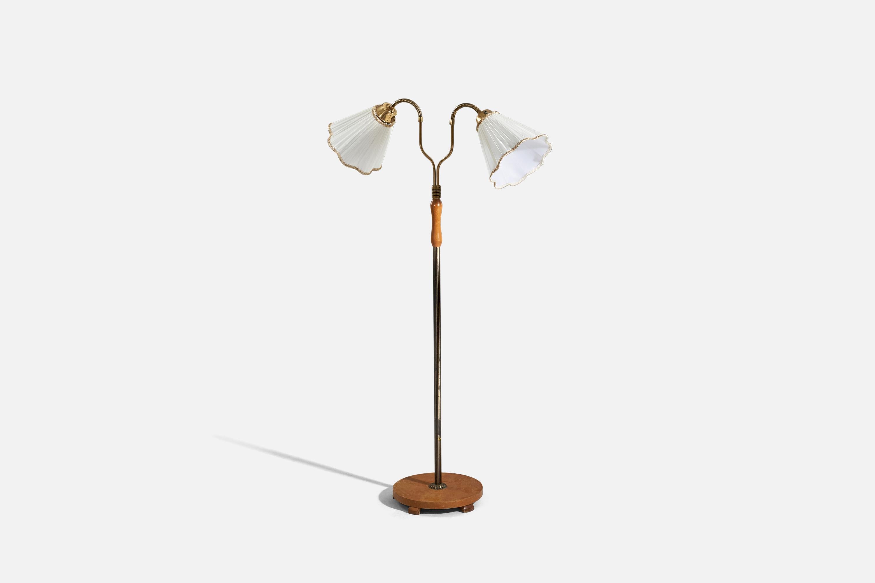 A brass, wood and fabric floor lamp designed and produced by a Swedish designer, Sweden, 1940s. 

Variable dimensions, measured as illustrated in the first image. 
Sold with lampshade. 
Stated dimensions refer to the floor lamp with the shade.
 