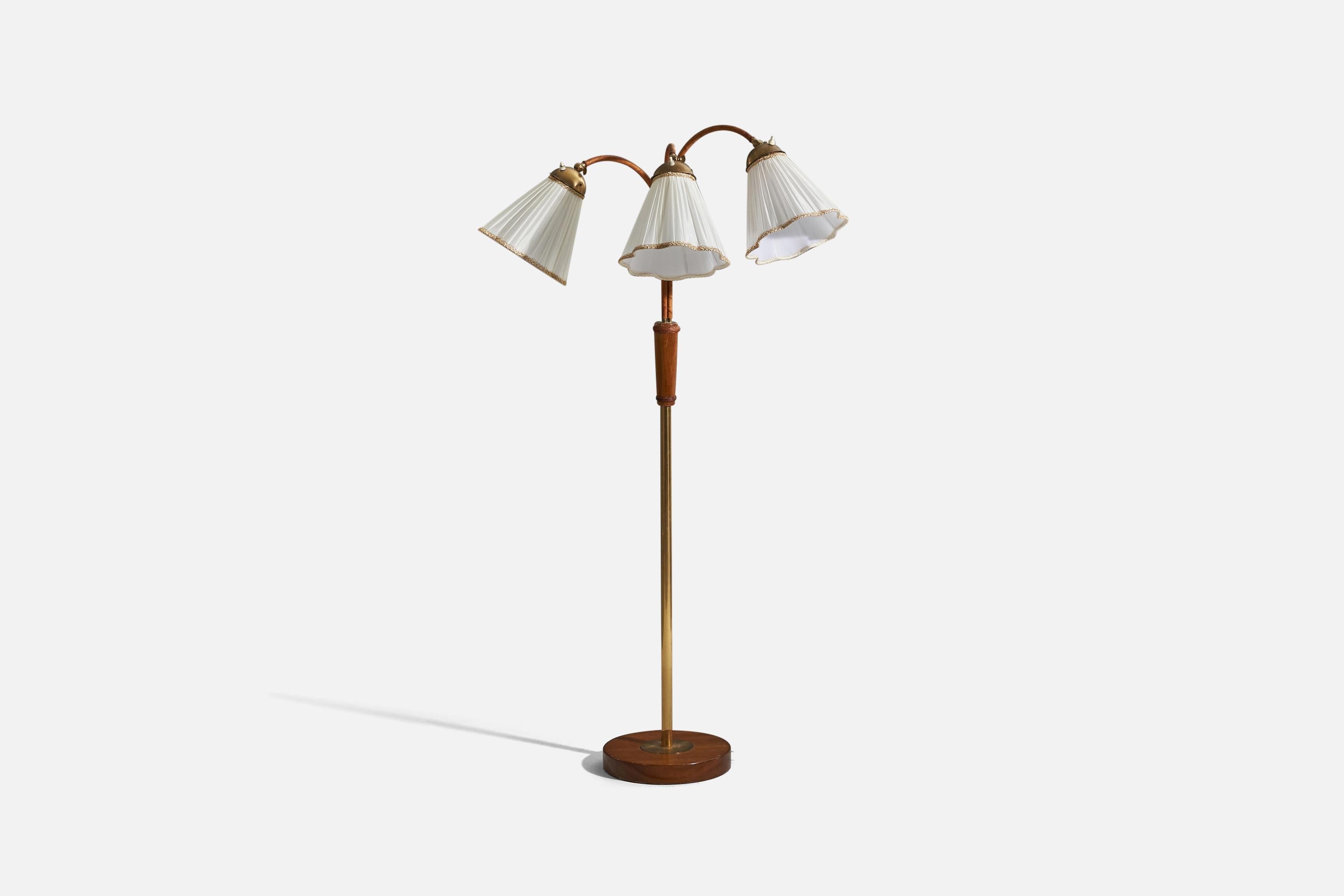 A brass, wood, leather and fabric floor lamp designed and produced by a Swedish designer, Sweden, 1950s. 

Sold with Lampshade. 
Dimensions stated refer to the floor lamp with the shade.

Variable dimensions, measured as illustrated in the