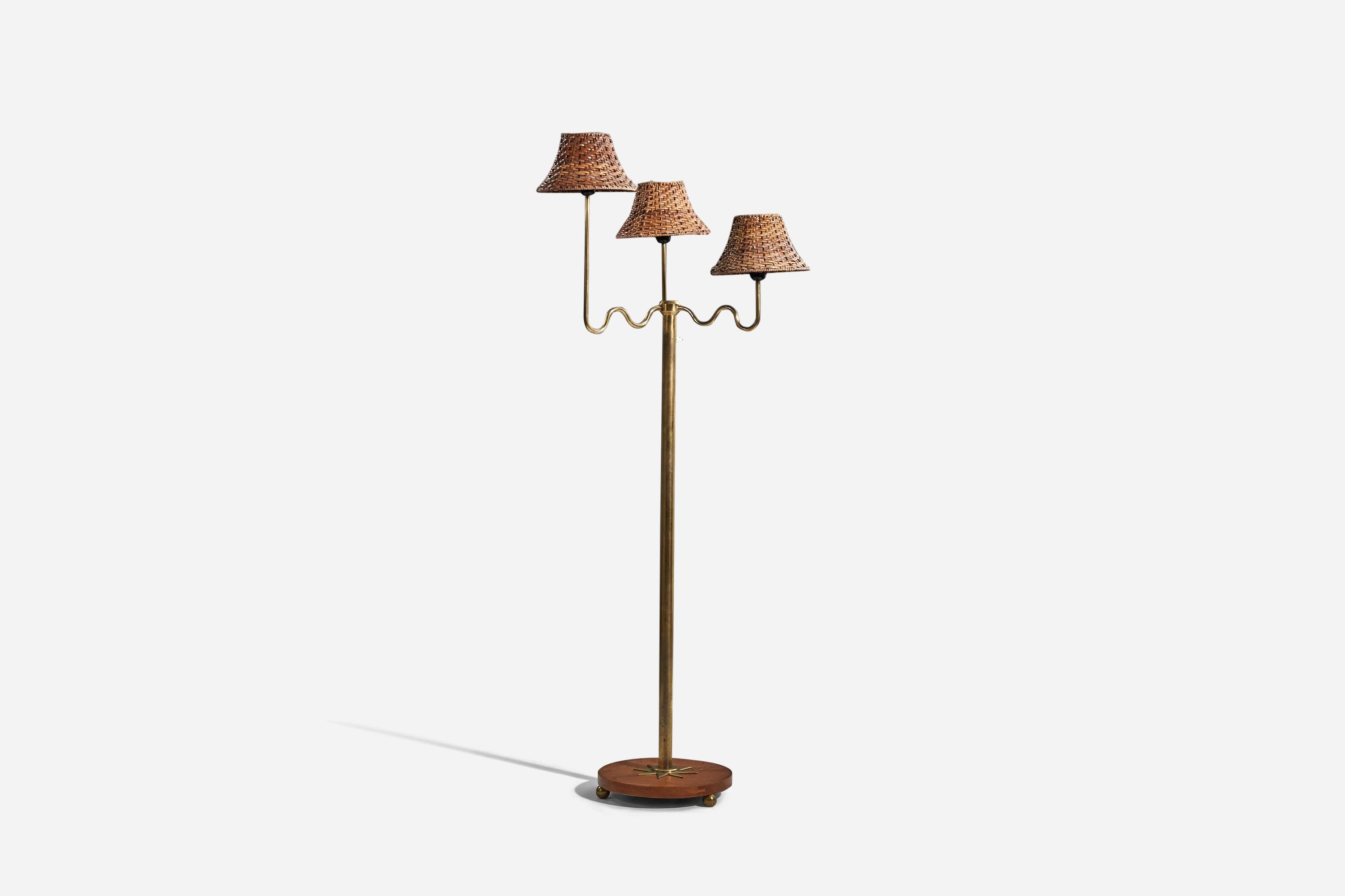 A brass, wood and rattan floor lamp designed and produced by a Swedish designer, Sweden, 1930s. 

Sold with lampshades. 
Stated dimensions refer to the floor lamp with lampshades.
 