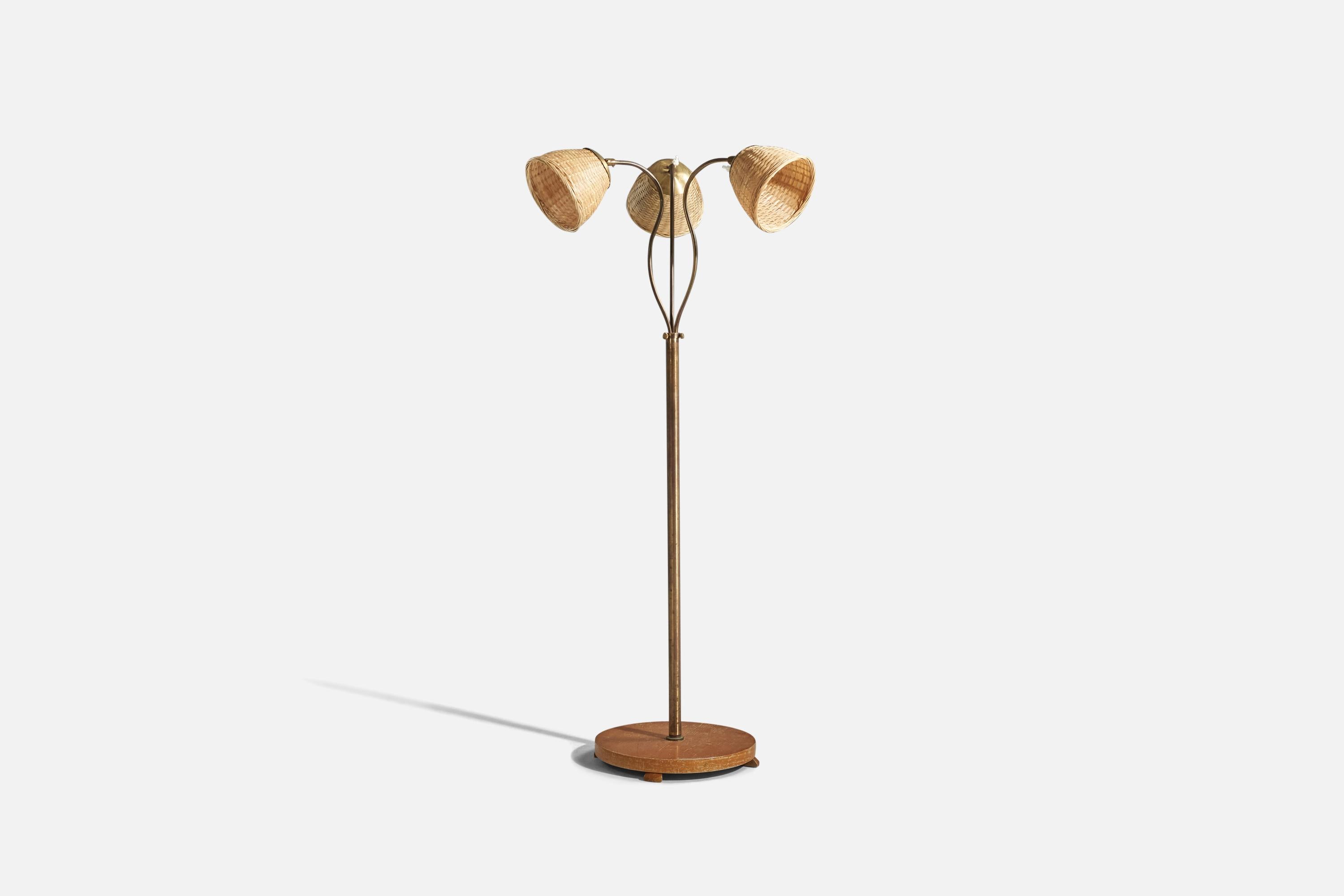 A brass, wood and rattan floor lamp designed and produced by a Swedish designer, Sweden, 1940s. 

Variable dimensions, measured as illustrated in the first image.
Sold with Lampshade(s). 
Stated dimensions refer to the Floor Lamp with the