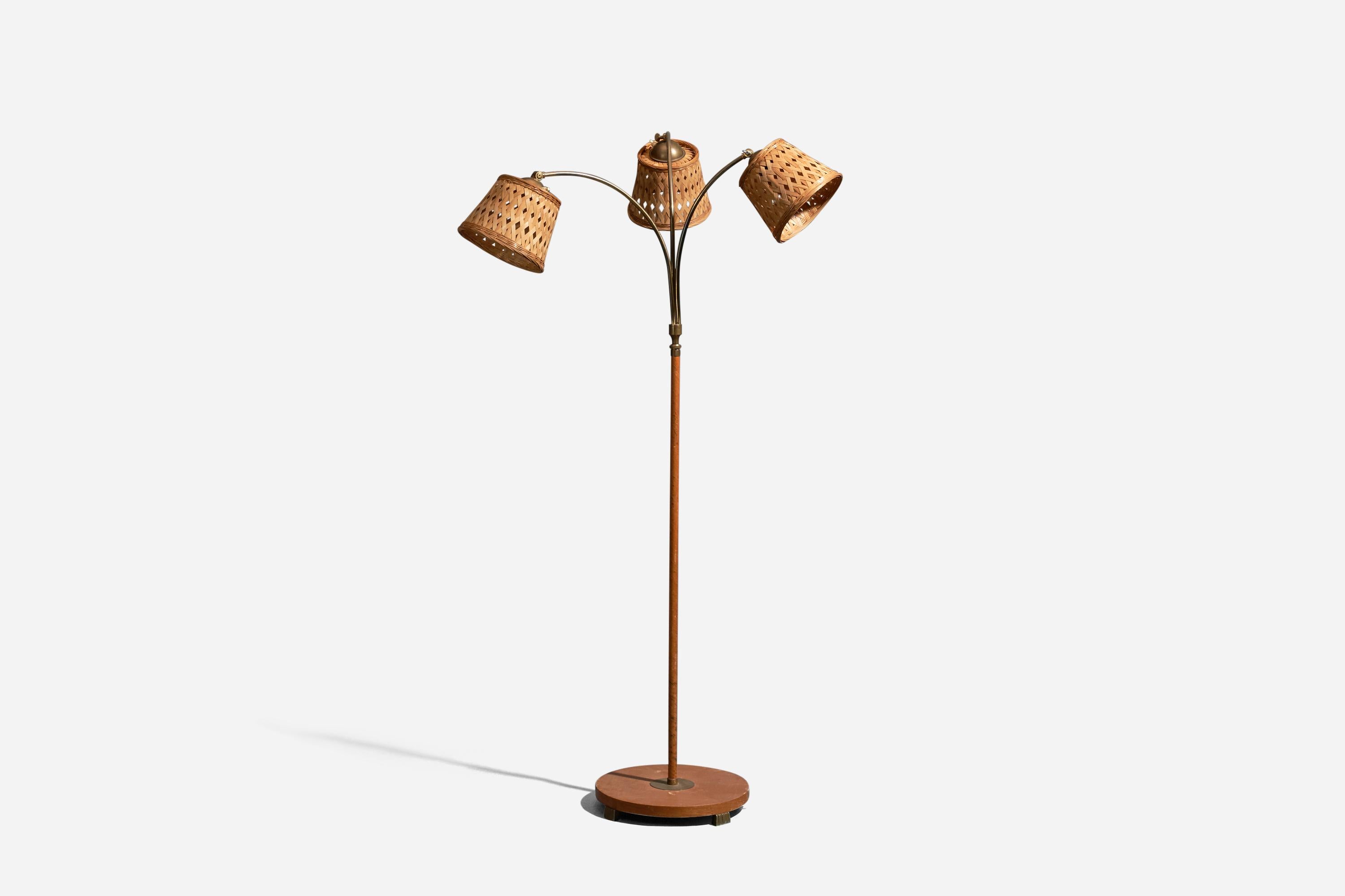 An adjustable, brass, wood, veneer and rattan floor lamp designed and produced in Sweden, 1930s.

Dimensions variable, measured as illustrated in first image.

Sold with Lampshades. Dimensions stated are of Floor Lamp with Lampshades.