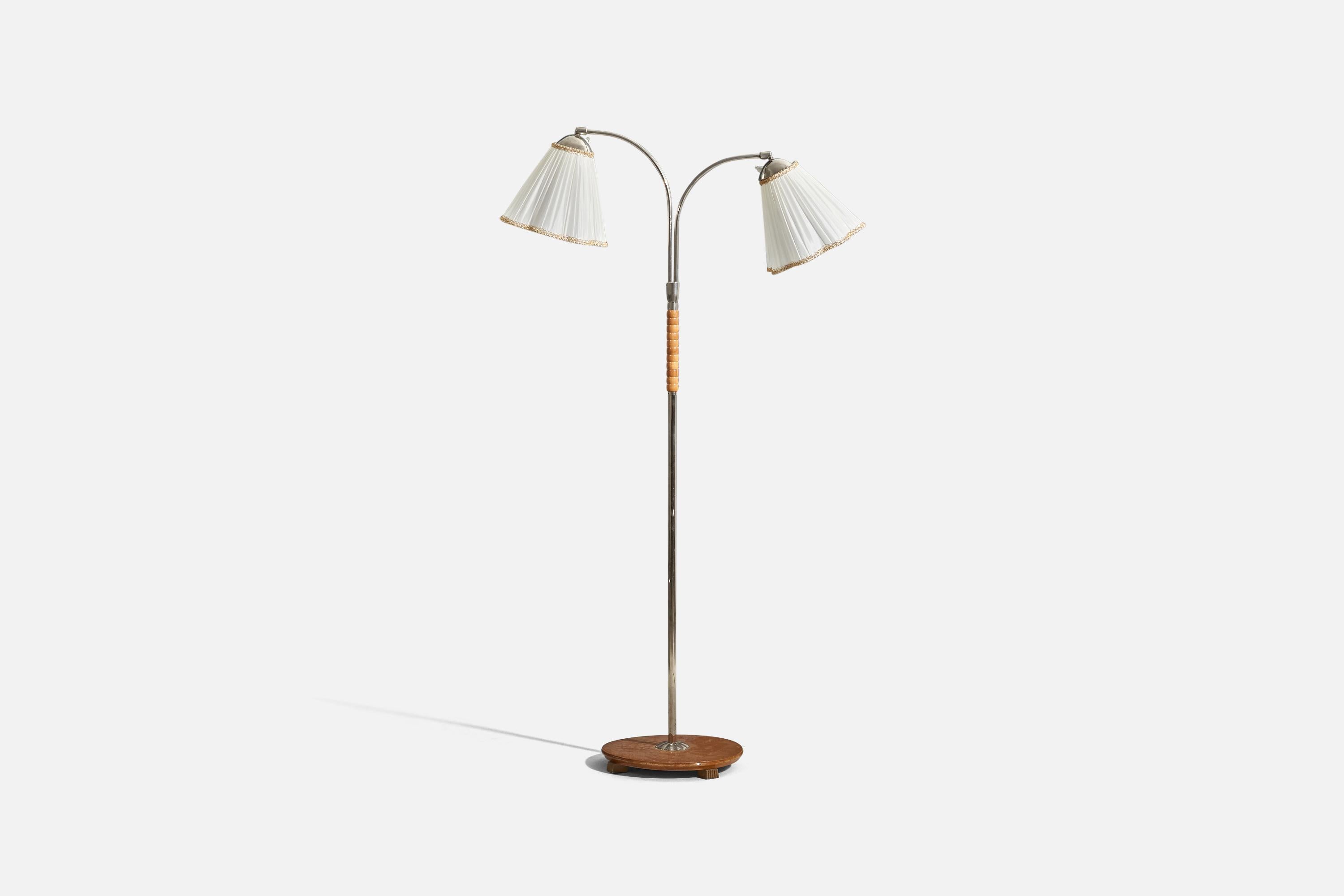 A chrome, wood and fabric floor lamp designed and produced by a Swedish designer, Sweden, 1940s. 

Sold with Lampshade. 
Dimensions stated refer to the floor lamp with the shade.

Variable dimensions, measured as illustrated in the first image.