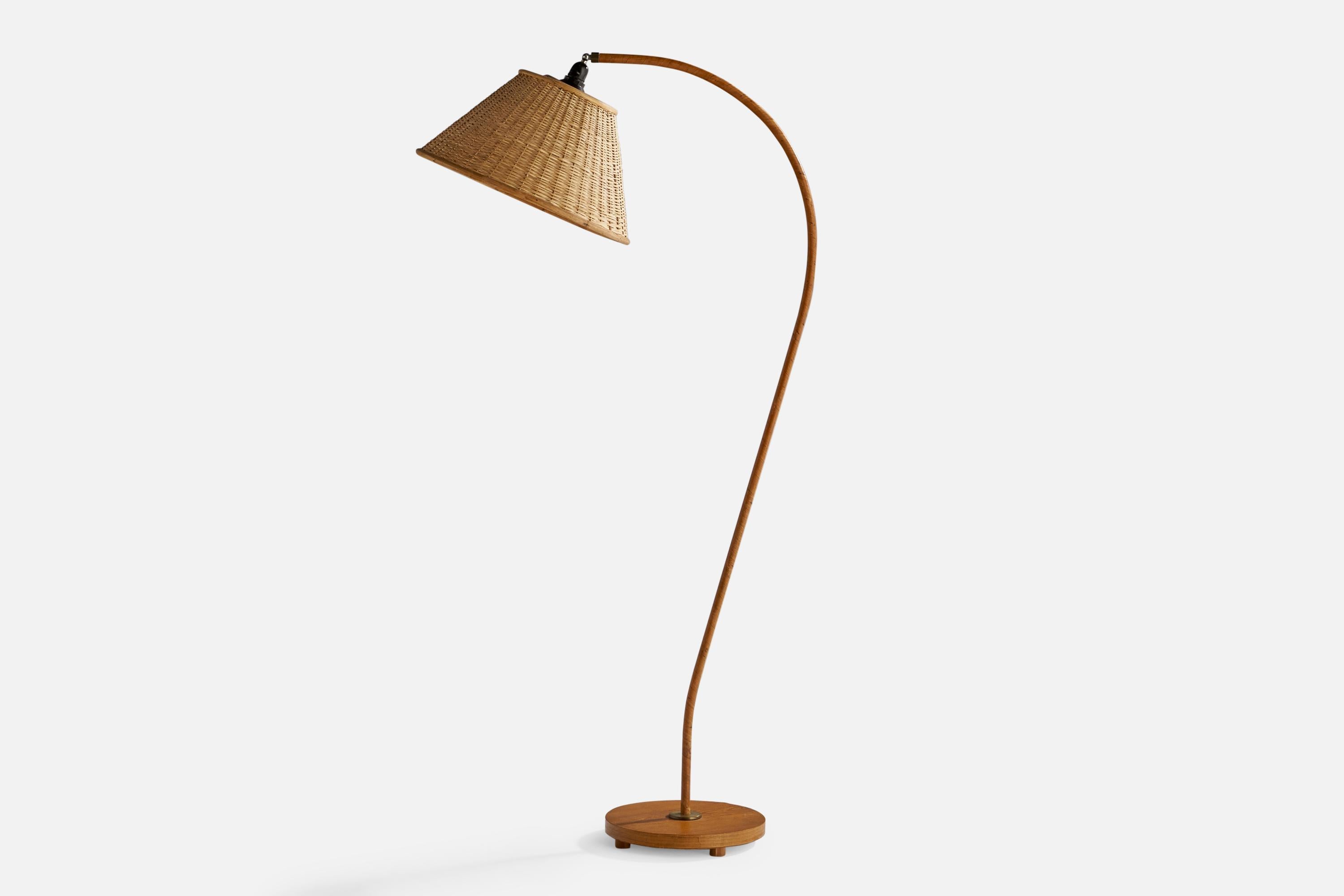A curved elm, wood veneer, brass and rattan floor lamp designed and produced in Sweden, c. 1940s.

Overall Dimensions (inches): 65” H x 18.75” W x 28.75” D
Bulb Specifications: E-26 Bulb
Number of Sockets: 1
 
All lighting will be converted for US
