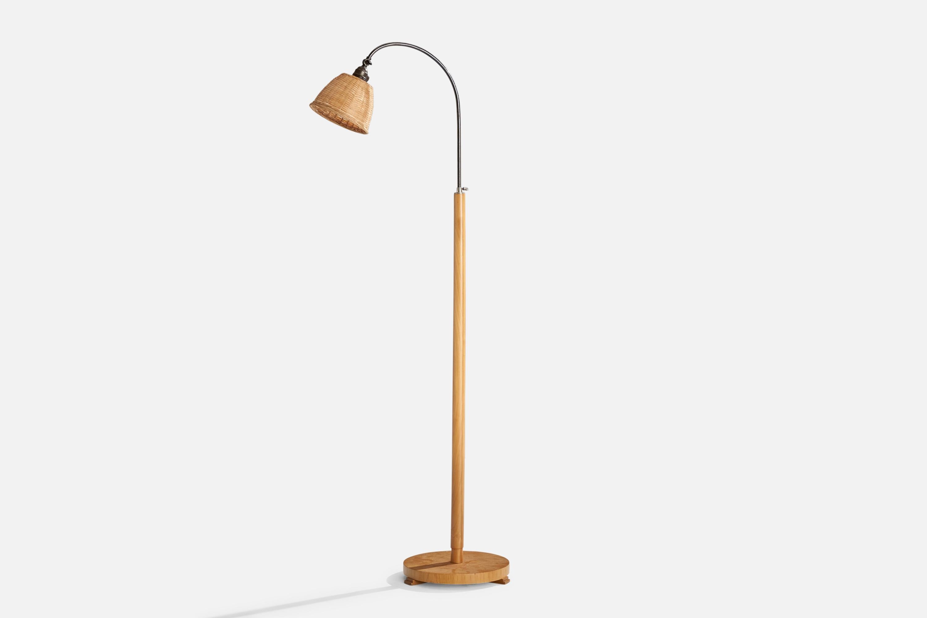 An adjustable birch, metal and rattan floor lamp designed and produced in Sweden, c. 1940s.

Dimensions variable 
Overall Dimensions (inches): 58.5” H x 6.5” W x 22” D
Stated dimensions include shade.
Bulb Specifications: E-26 Bulb
Number of