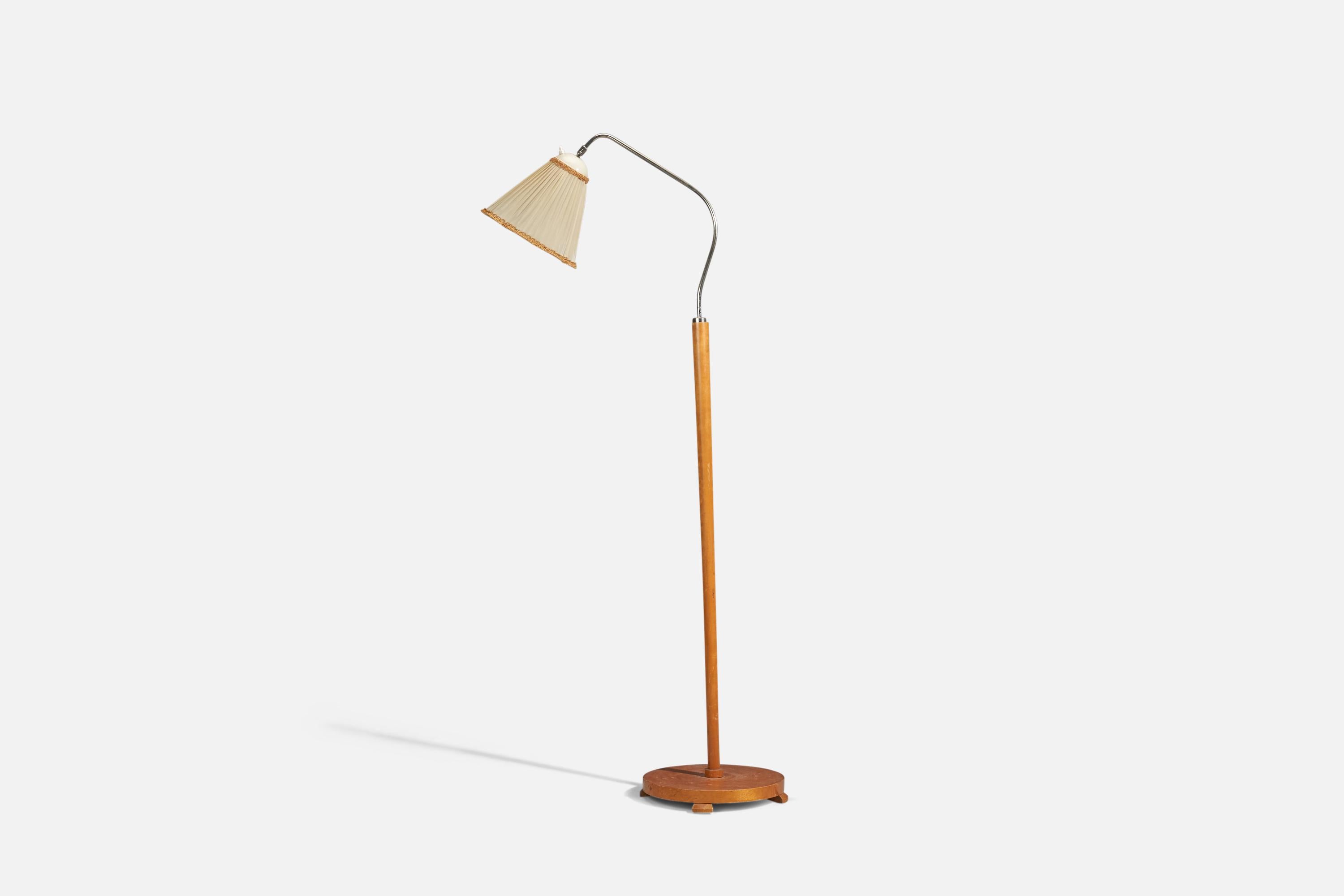 An adjustable metal and wood floor lamp designed and produced in Sweden, 1940s.

Dimensions variable, measured as illustrated in first image.

Dimensions stated are of Floor Lamp with Lampshade. 

Socket takes standard E-26 medium base bulb.

There