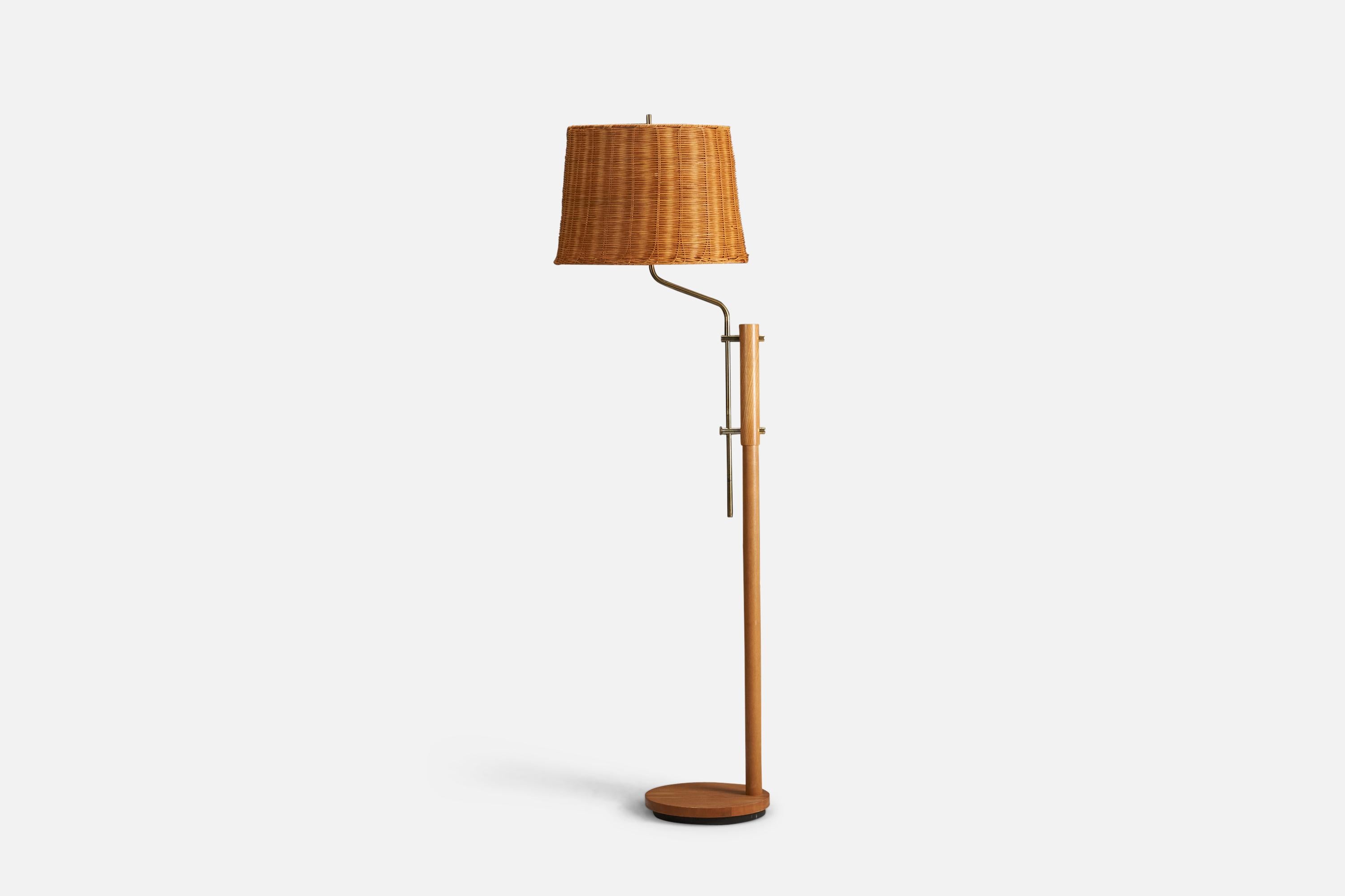A oak, brass and rattan floor lamp designed and produced by a Swedish Designer, Sweden, 1970s.

Sockets take standard E-26 medium base bulbs.

There is no maximum wattage stated on the fixture.