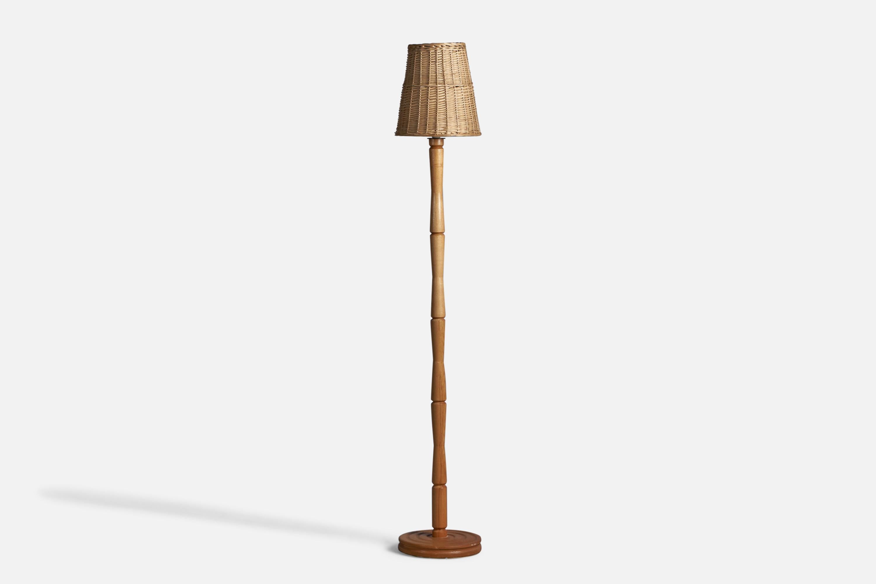 An oak and rattan floor lamp, designed and produced in Sweden, c. 1970s.

Overall Dimensions (inches): 64.5