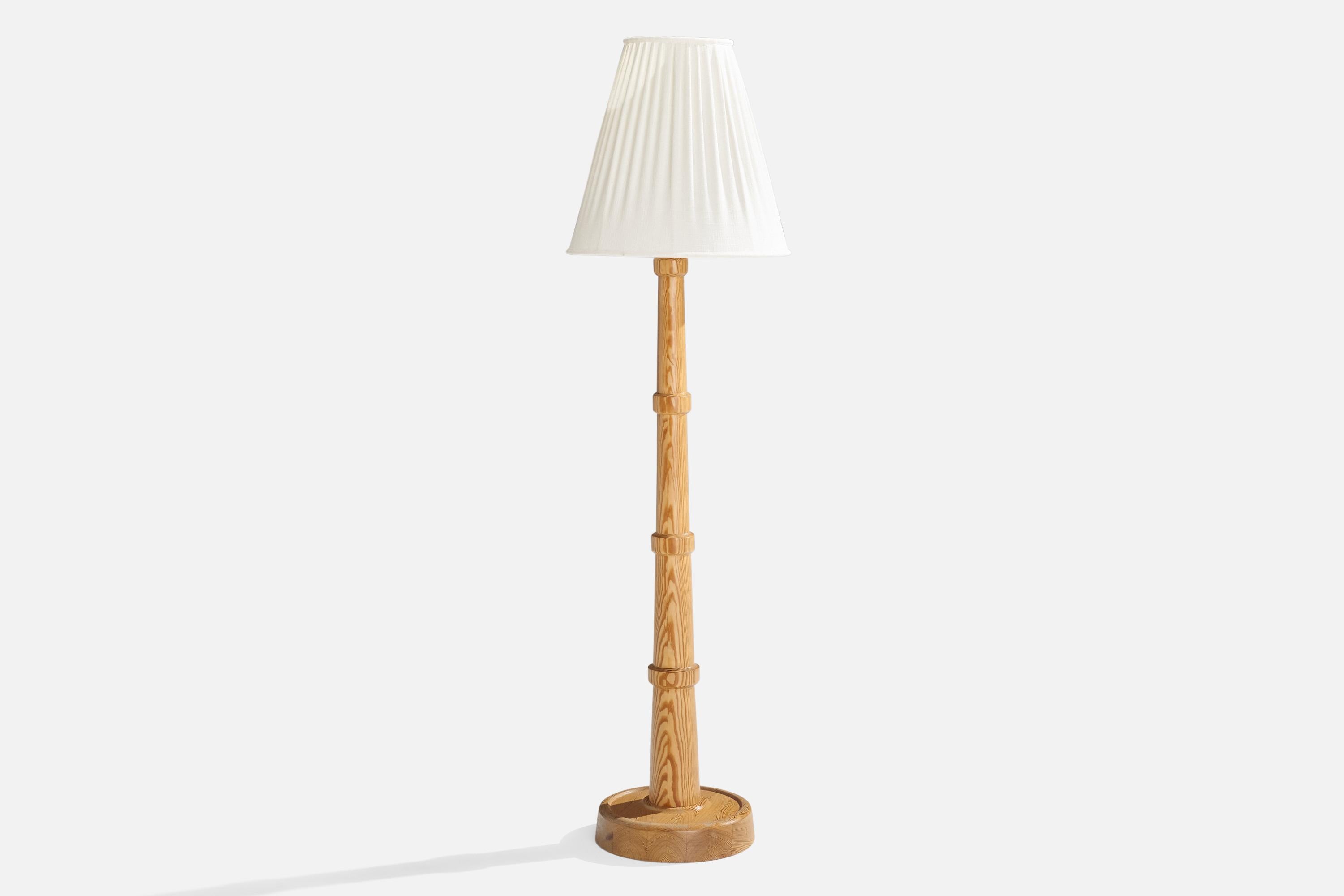 A pine floor lamp designed and produced in Sweden, c. 1960s.

Overall Dimensions (inches): 51.25” H x 14” W x 14.25” D
Stated dimensions include shade.
Bulb Specifications: E-26 Bulb
Number of Sockets: 1
All lighting will be converted for US usage.