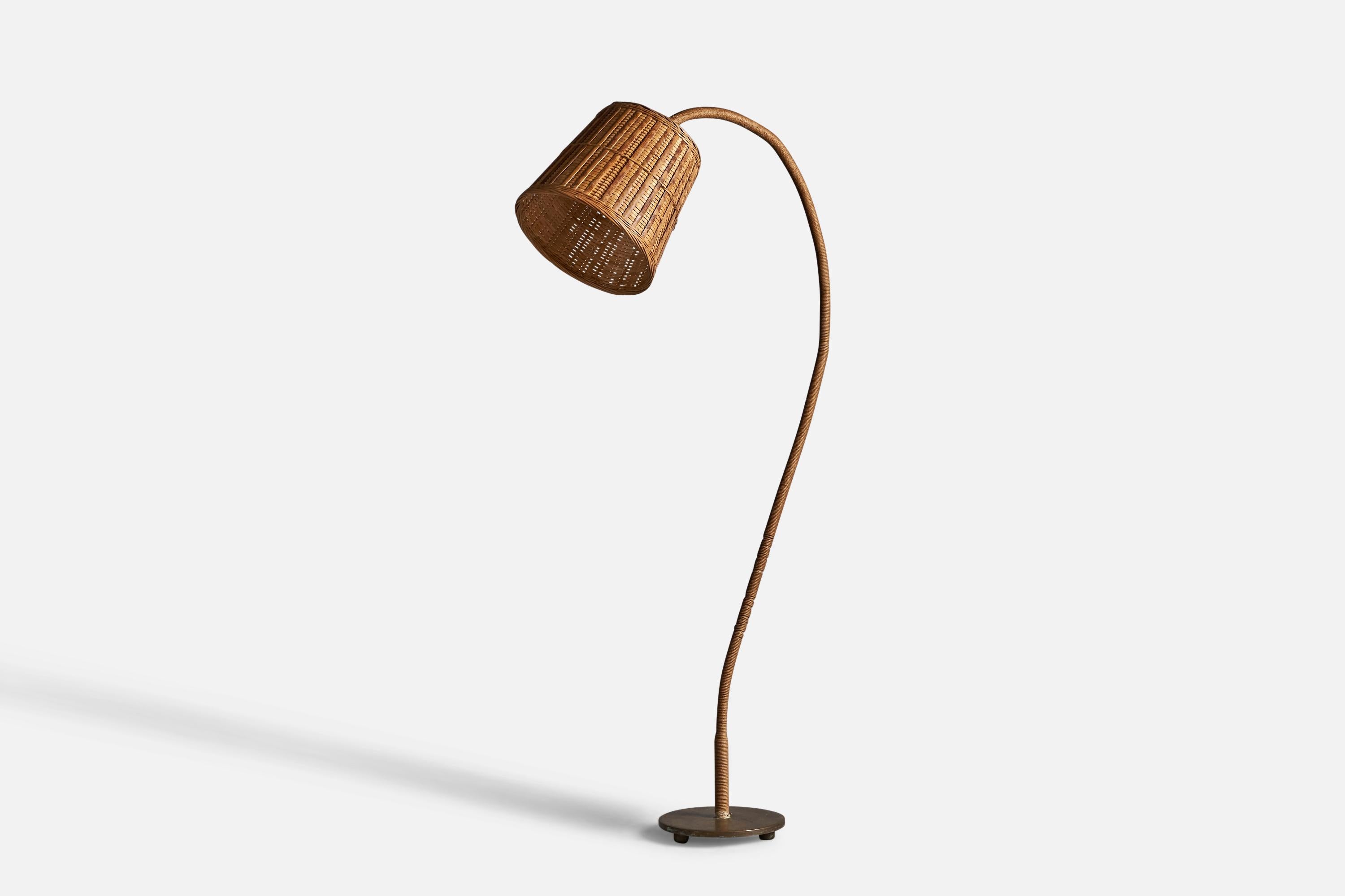 A curved rattan, cord, brass, and wood floor lamp, designed and produced in Sweden, 1930s.

Overall Dimensions (inches): 59