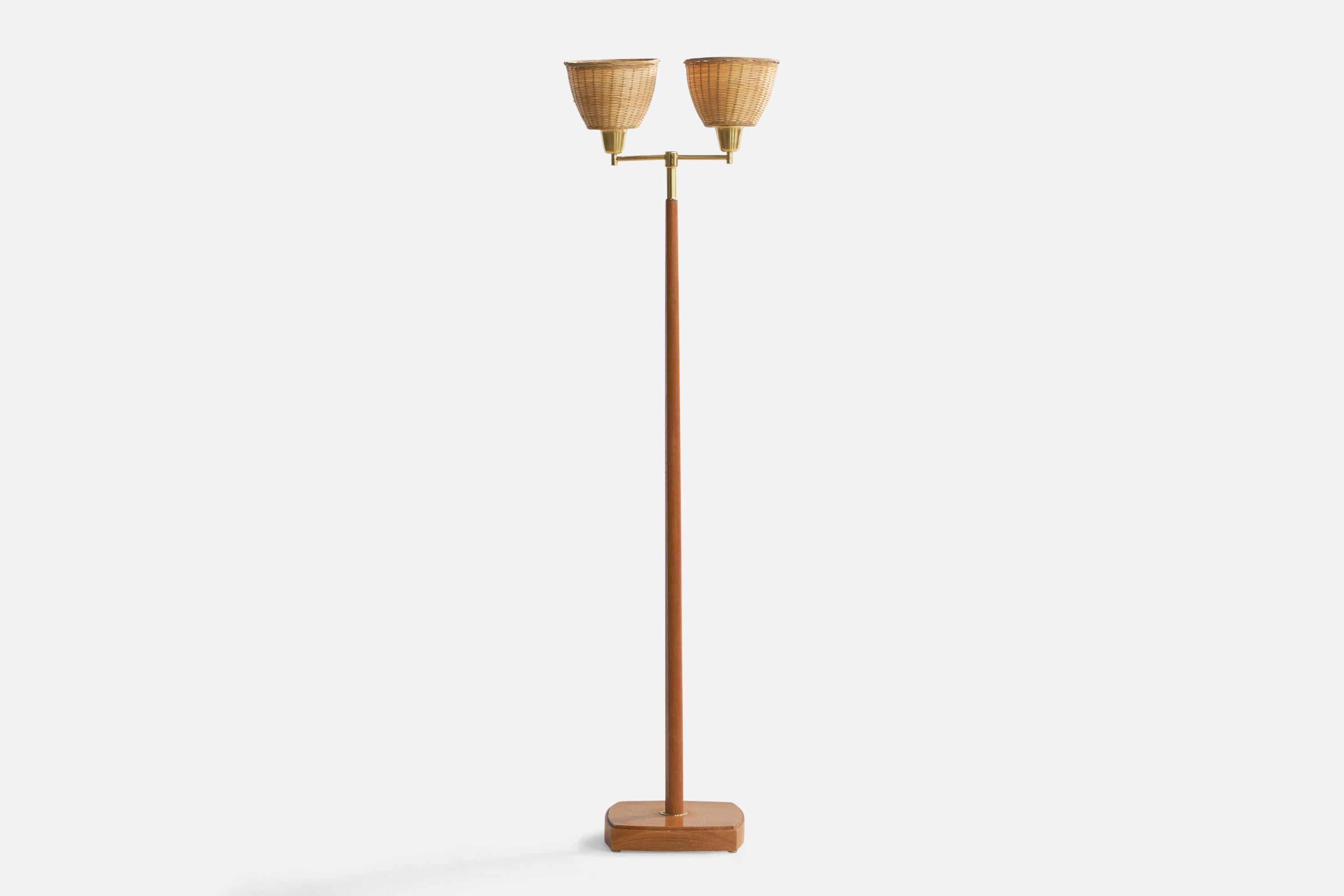 A two-armed brass, teak and rattan floor lamp designed and produced in Sweden, c. 1950s.

Overall Dimensions (inches): 54.8” H x 15” W x 10.25” D
Bulb Specifications: E-26 Bulbs
Number of Sockets: 2
All lighting will be converted for US usage. We