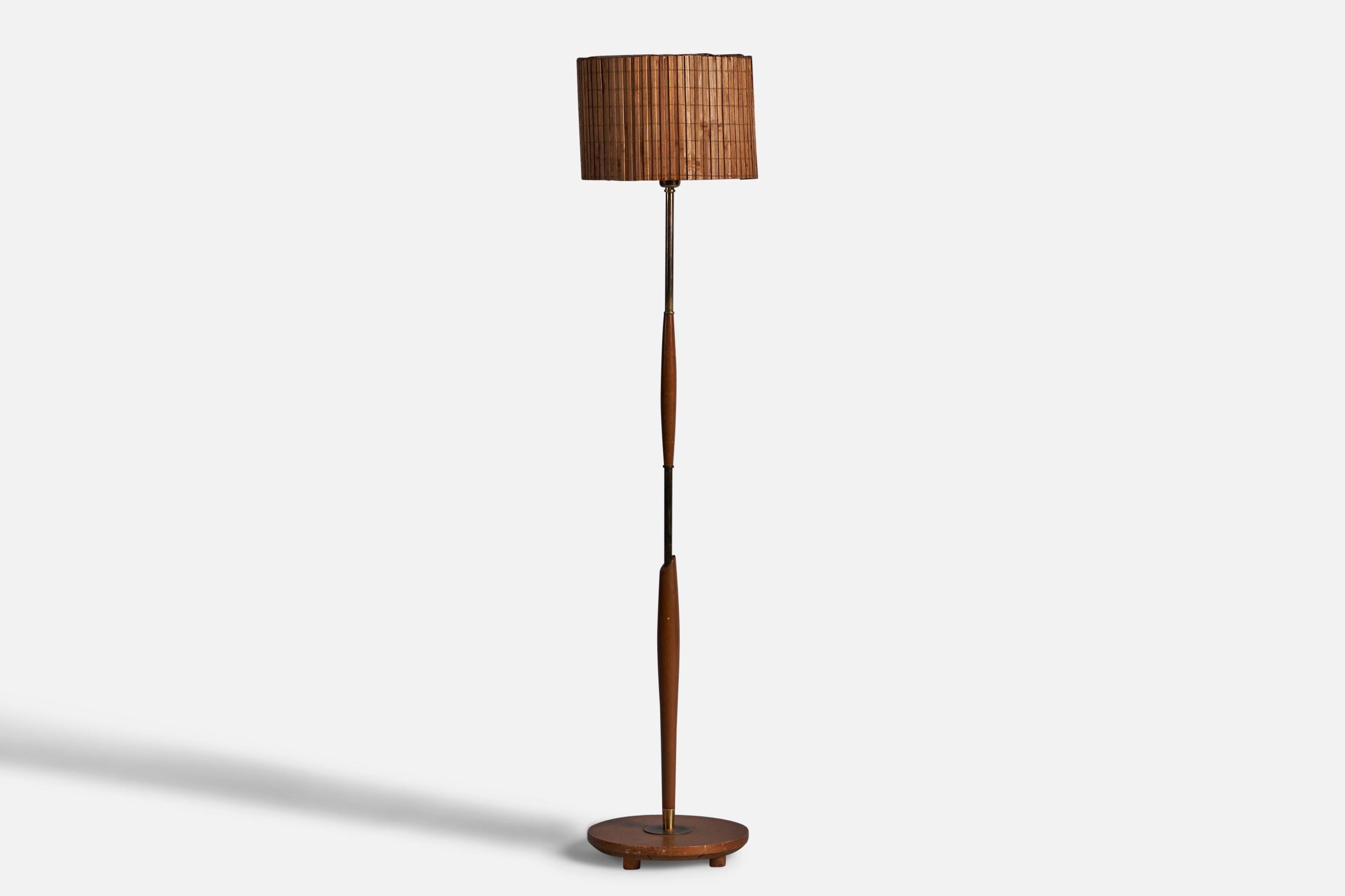 A teak, brass and woven reed floor lamp designed and produced in Sweden, c. 1950s.

Overall Dimensions (inches): 56.4” H x 12.5” Diameter
Bulb Specifications: E-26 Bulb
Number of Sockets: 1
