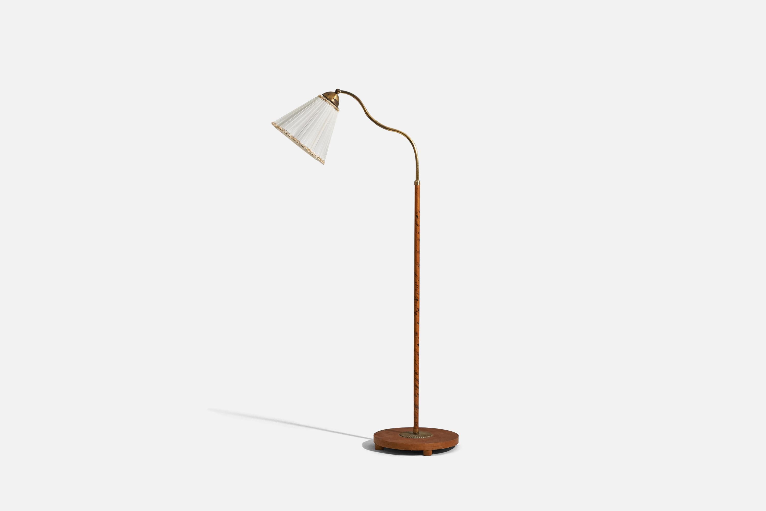 An adjustable, wood, brass and fabric floor lamp designed and produced by a Swedish designer, Sweden, 1930s. 

Variable dimensions. Dimensions listed refer to the lamp mounted as illustrated in the first image.