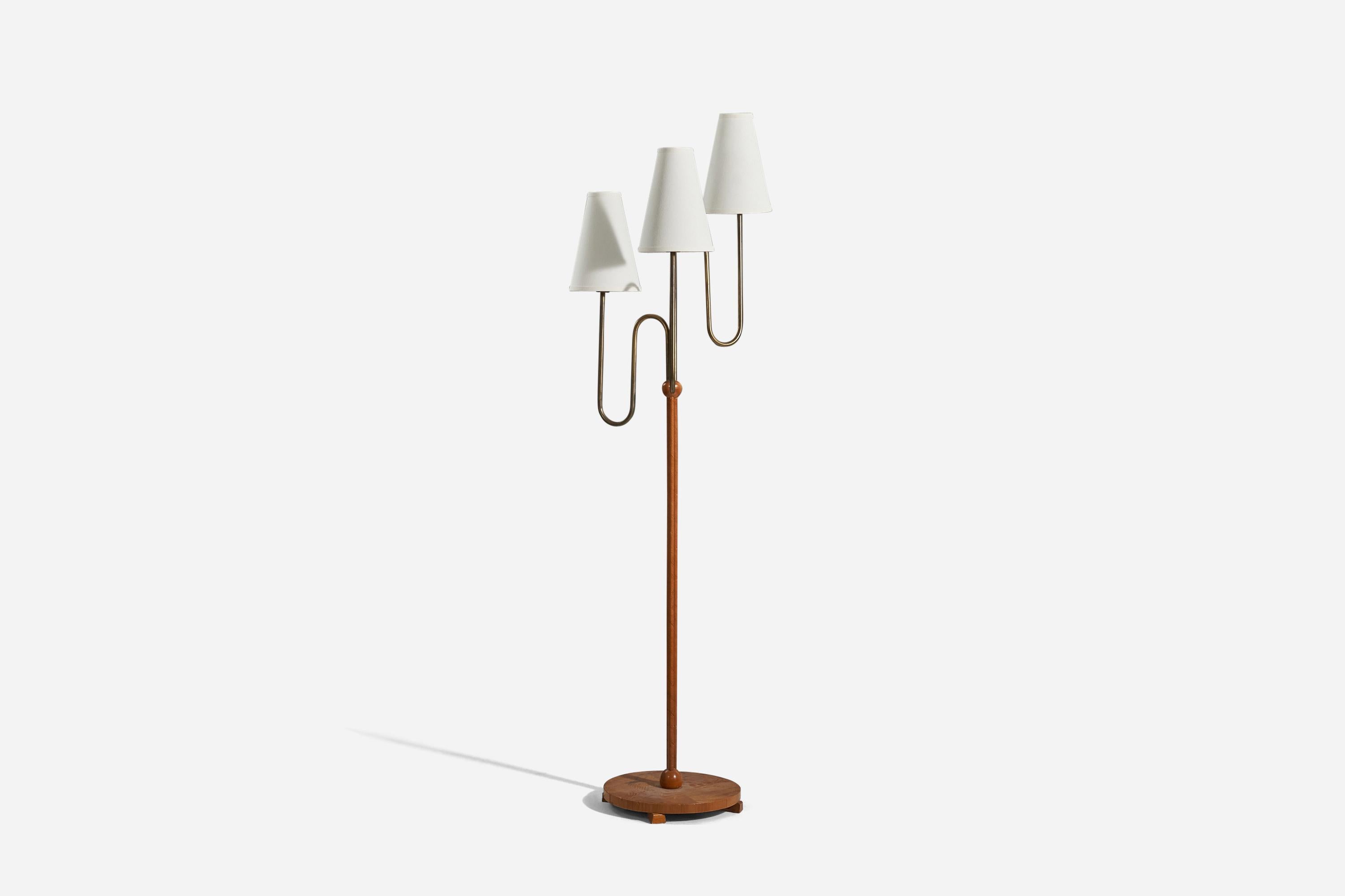 A brass, wood and fabric floor lamp designed and produced by a Swedish designer, Sweden, 1930s. 

Sold with lampshade. 
Stated dimensions refer to the floor lamp with lampshades.
  