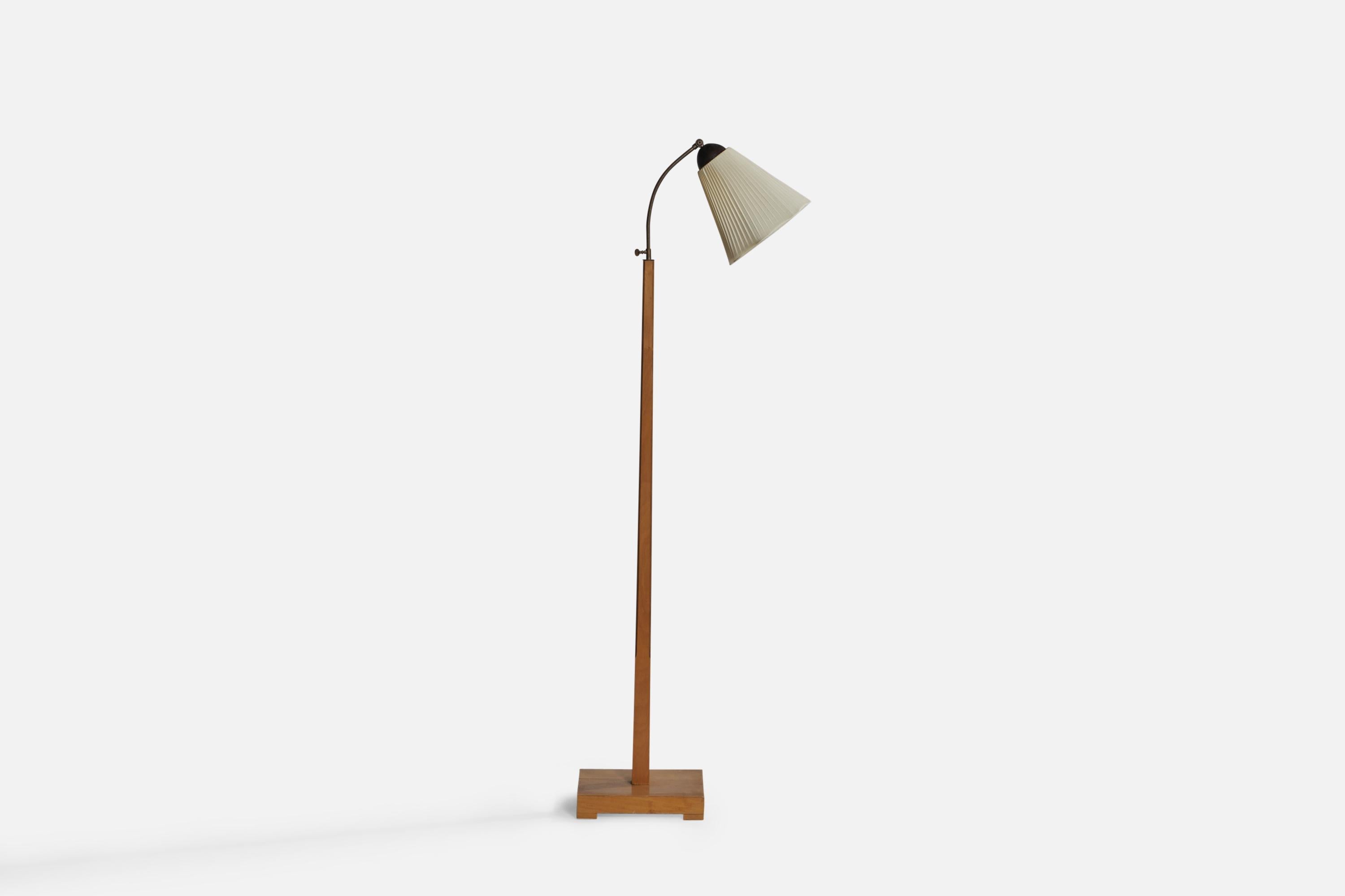An adjustable brass, wood and off-white fabric floor lamp designed and produced in Sweden, 1930s.

Overall Dimensions (inches): 58.8” H x 11.2” W 20.9” D. Stated dimensions include shade.
Dimensions vary based on position of light.
Bulb