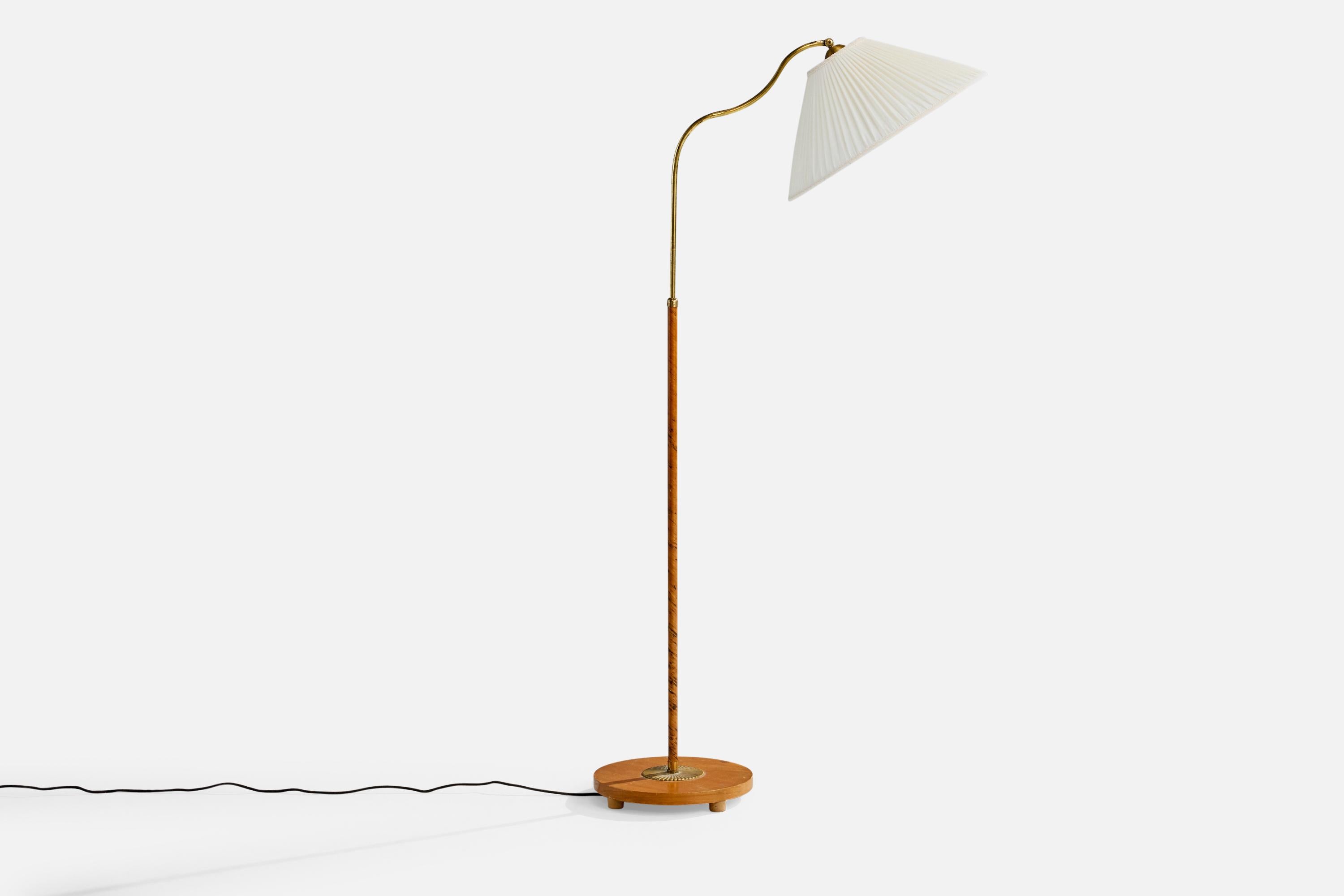 An adjustable brass, wood and off-white fabric floor lamp designed and produced in Sweden, c. 1930s.

Oxidation present to brass. 

Brand new fabric lampshade. 

Wear to wood consistent with age and use

Wear consistent with age and use

Height and