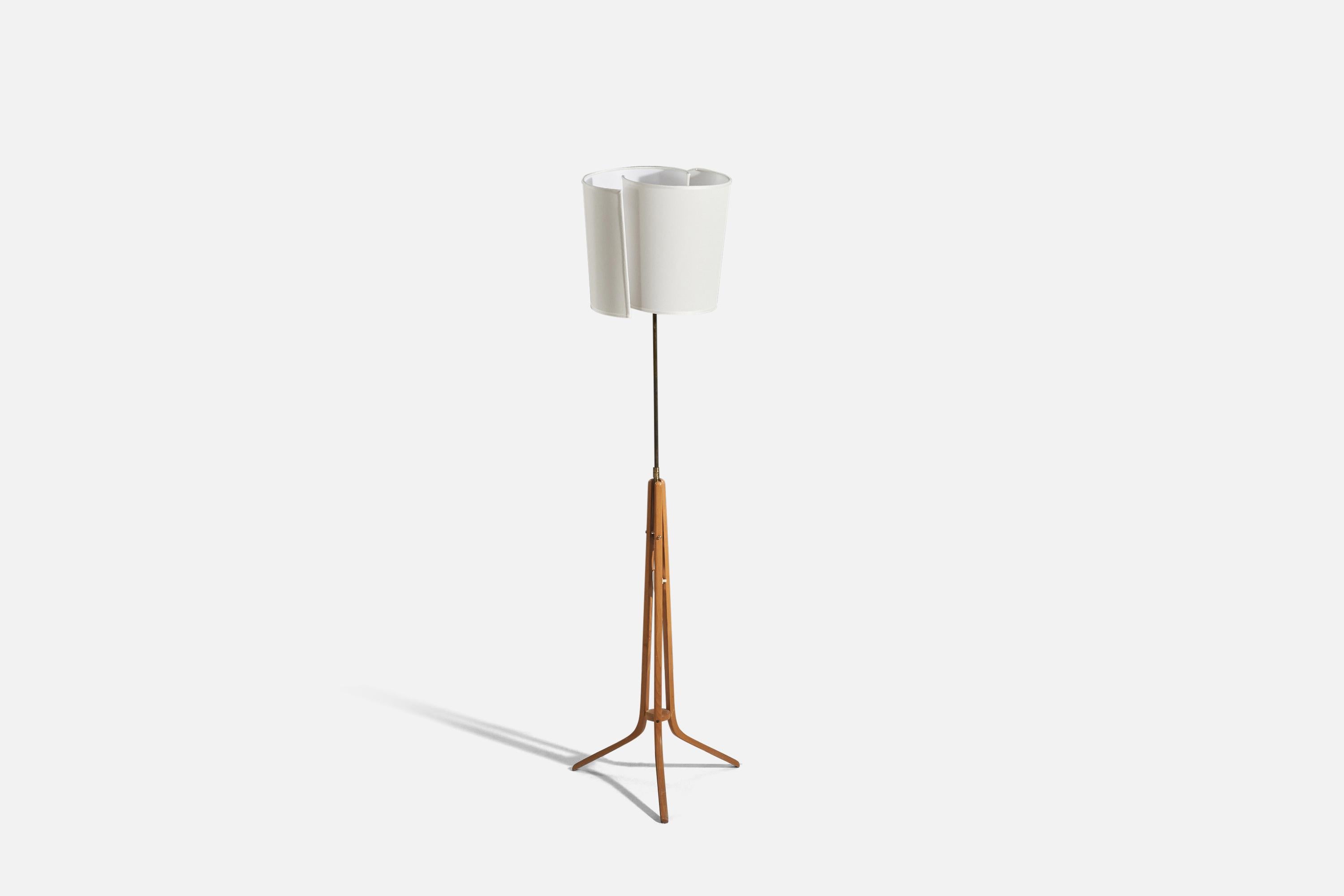 A brass, wood and fabric floor lamp designed and produced by a Swedish designer, Sweden, 1950s. 

Sold with lampshade. 
Stated dimensions refer to the floor lamp with the lampshades.


