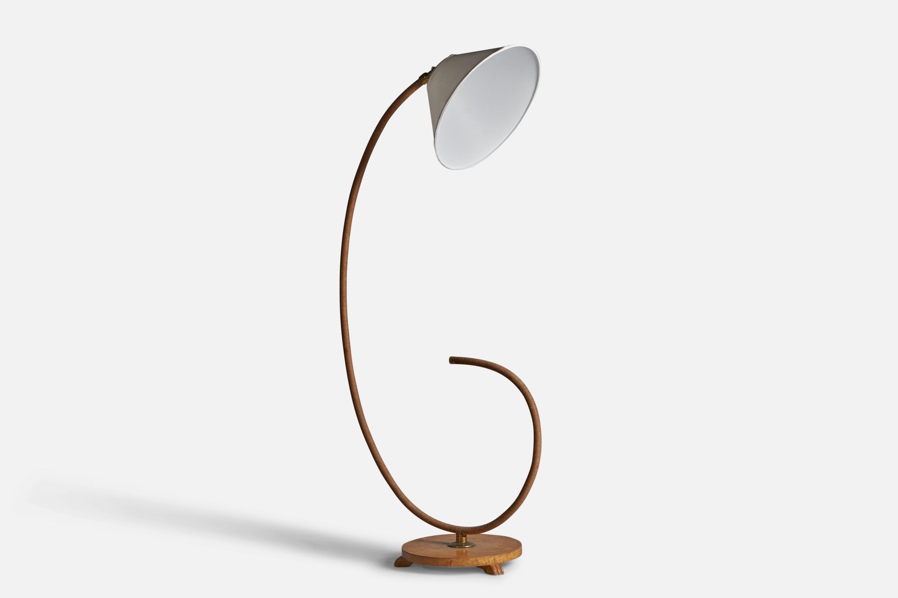 A curved brass, cord, white fabric and wood floor lamp, designed and produced in Sweden, c. 1930s.

Overall Dimensions: 65