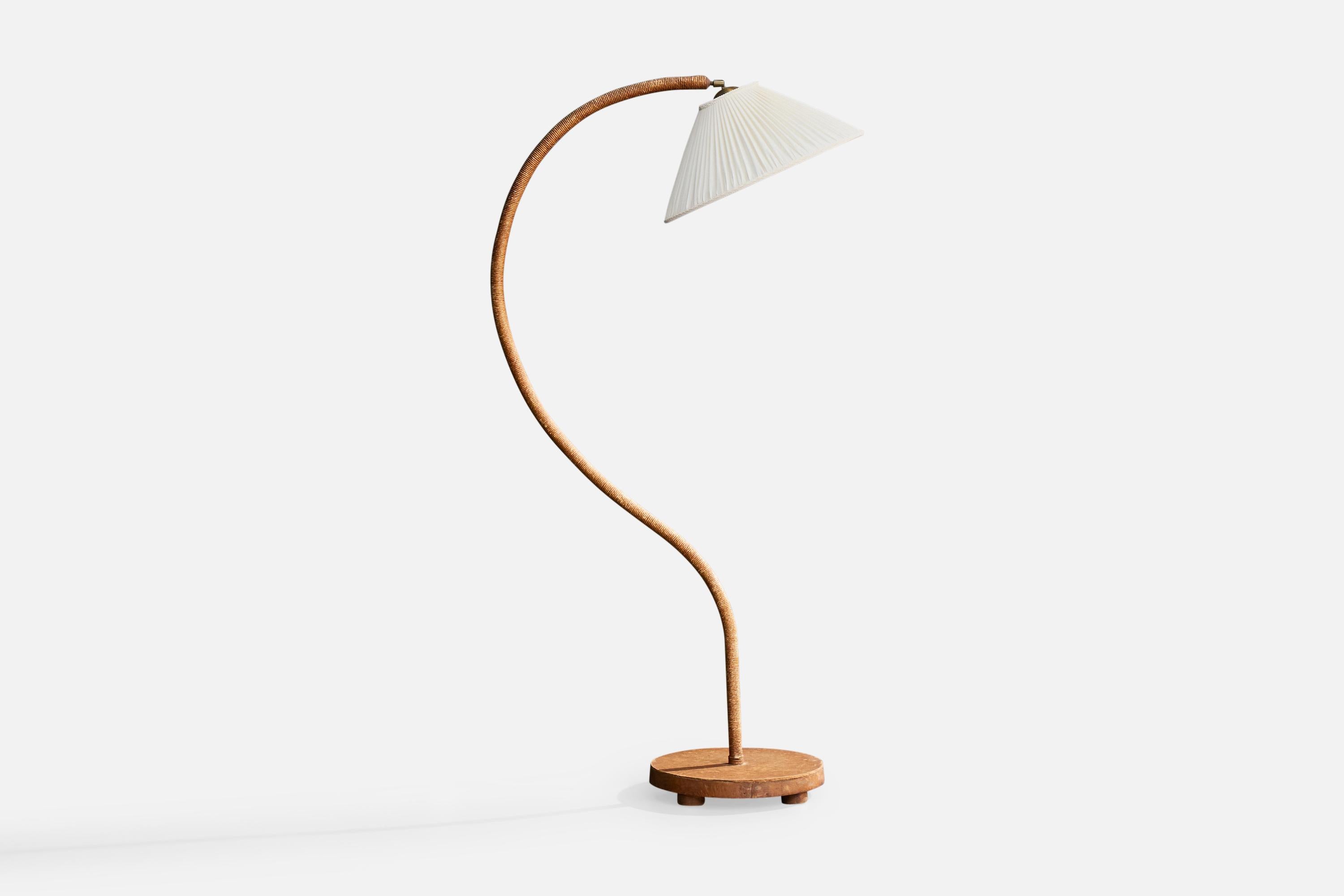 An adjustable, wood, cord and white fabric floor lamp designed and produced in Sweden, 1930s.

Dimensions of Lamp with Shade (inches): 61.5