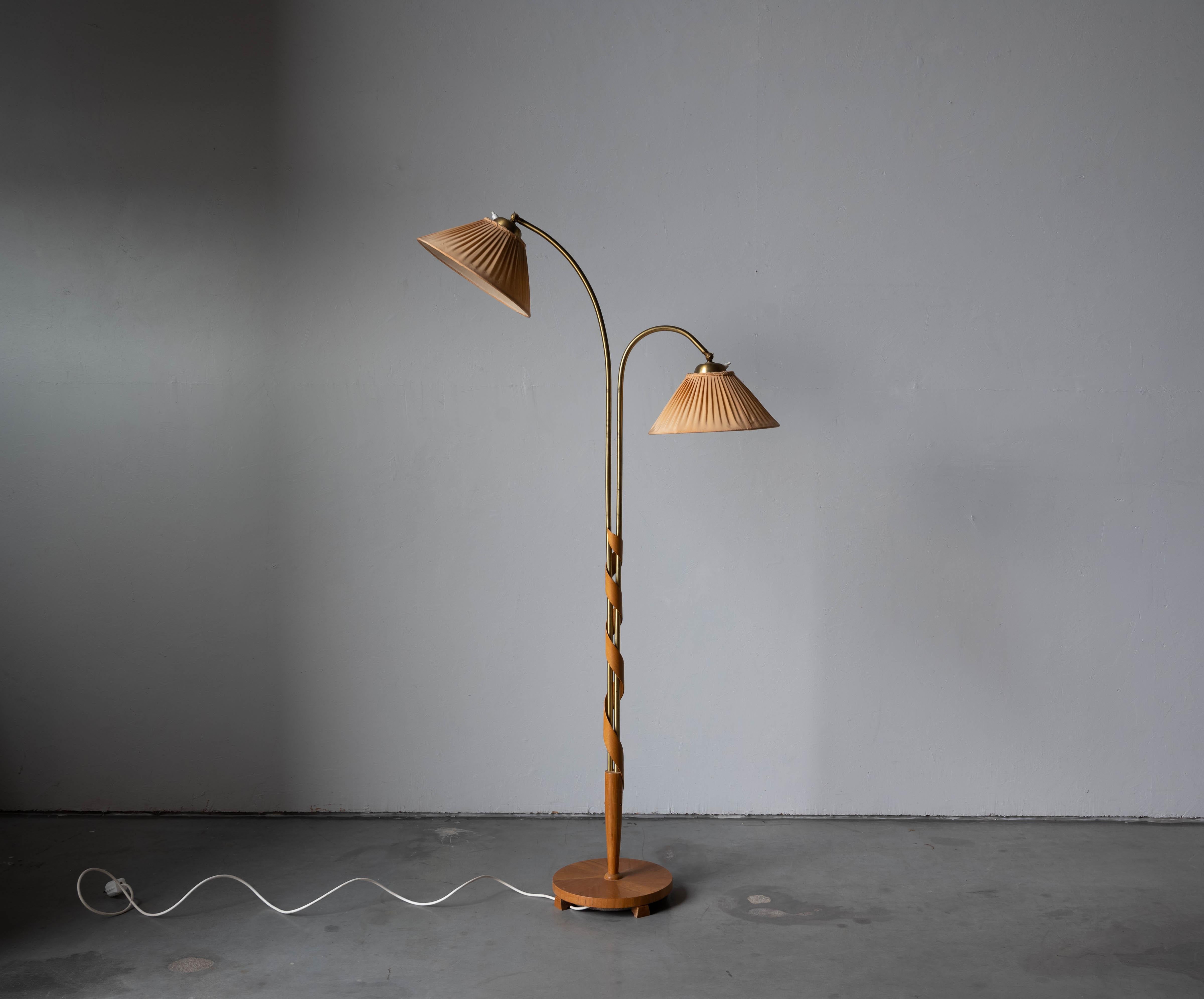 A wood and fabric floor lamp designed and produced by a Swedish designer, Sweden, 1930s. 

Sold with lampshades. 
Stated dimensions refer to the floor lamp with lampshades.
 