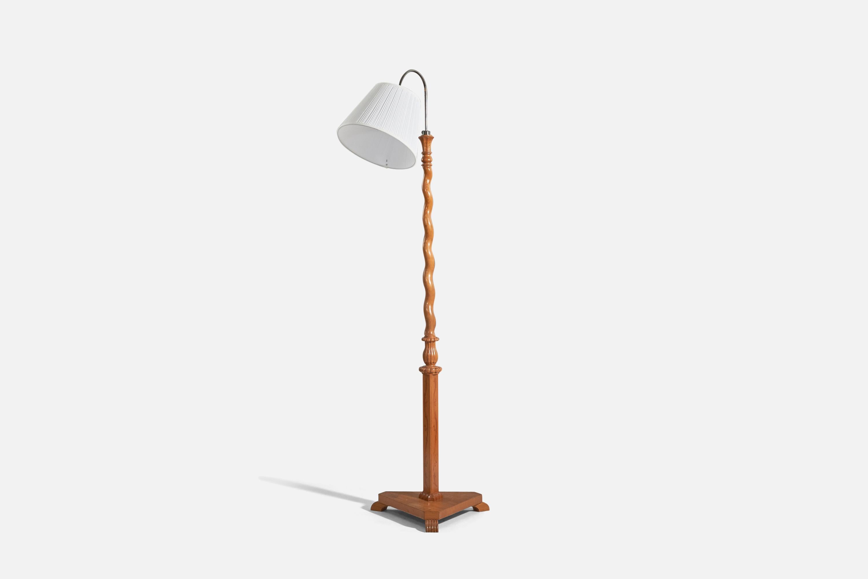 A metal, wood and fabric floor lamp designed and produced by a Swedish designer, Sweden, 1940s. 

Sold with lampshade. 
Stated dimensions refer to the floor lamp with the shade.
 