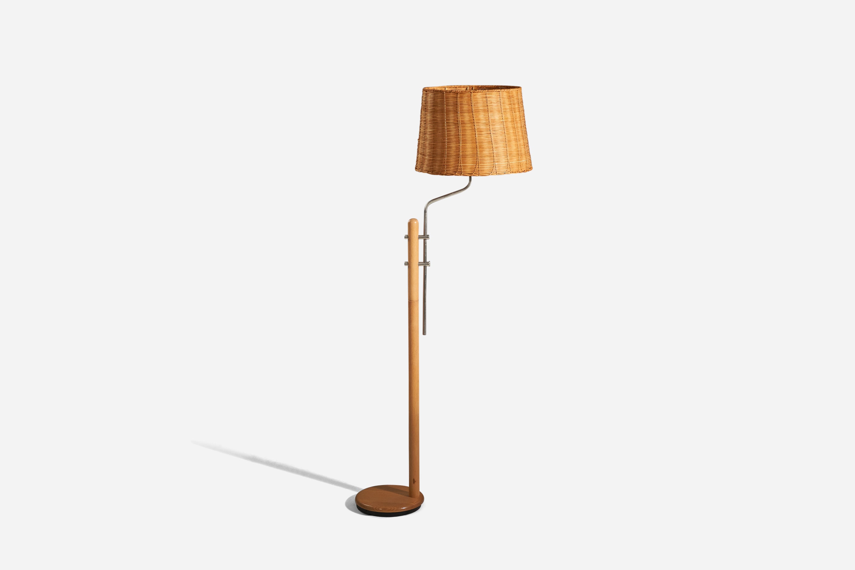 A wood, steel and rattan floor lamp designed and produced by a Swedish designer, Sweden, c. 1970s.

Sold with Lampshade. 
Dimensions stated refer to the floor lamp with the shade.

