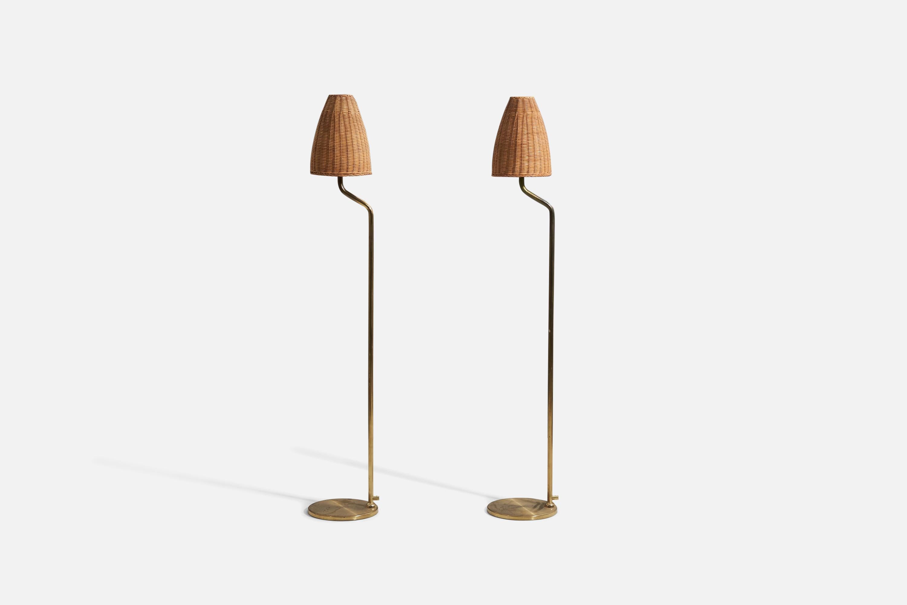 A pair of brass and rattan floor lamps designed and produced in Sweden, 1960s-1970s. 

