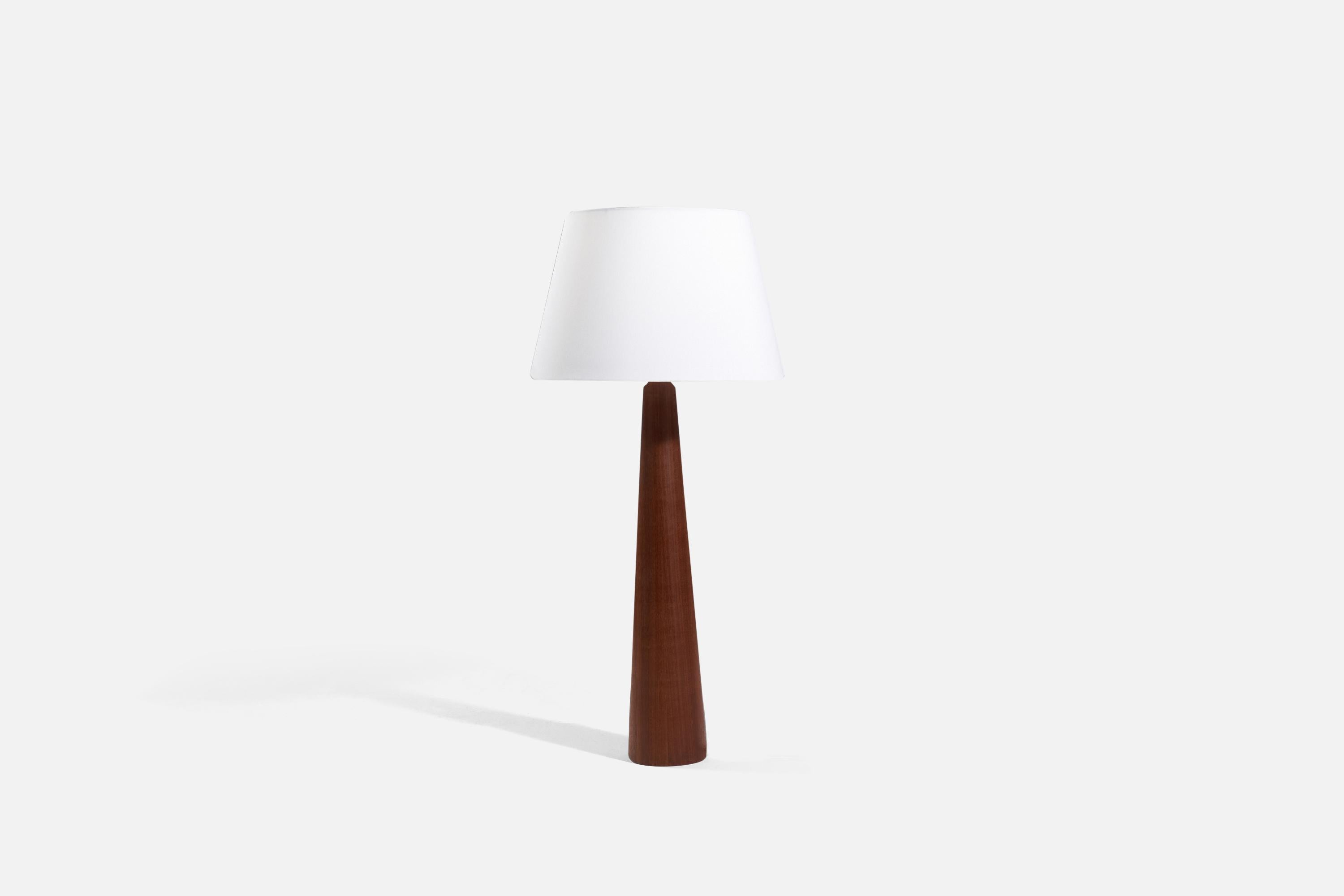 A wood table lamp or floor lamp designed and produced by a Swedish designer, Sweden, c.1960s.

Sold without lampshade. 
Dimensions of lamp (inches) : 35.125 x 5.625 x 5.625 (H x W x D).
Dimensions shade (inches) : 13 x 18 x 11.875 (T x B x