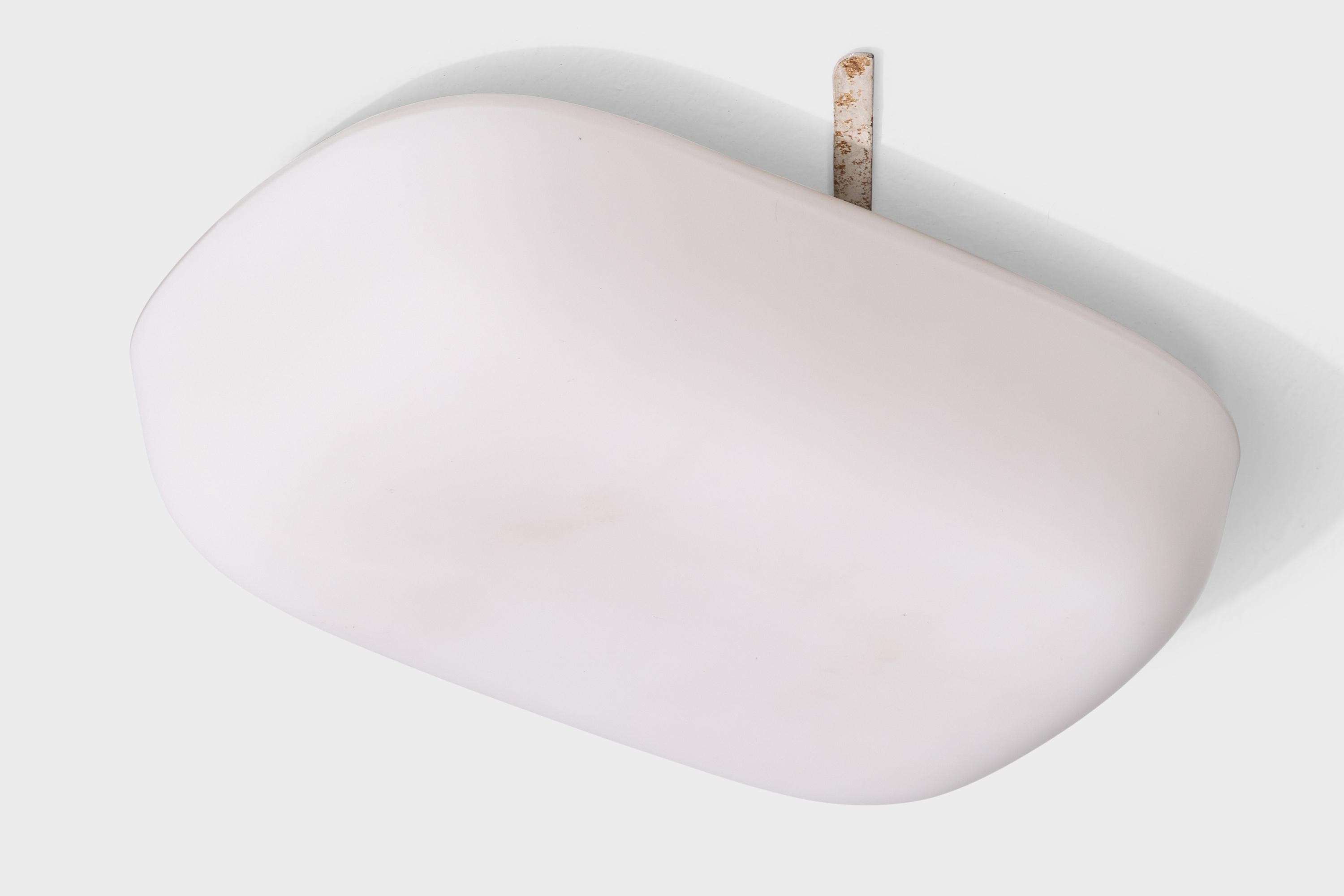 A white opaline glass flush mount likely designed and produced in Sweden, c. 1940s.

Light staining on top surface of glass flush mount.

Overall Dimensions (inches): 3.2” H x 11.75” W x 7.9“ D

Bulb Specifications: E-26

Number of Sockets: 1

Sold